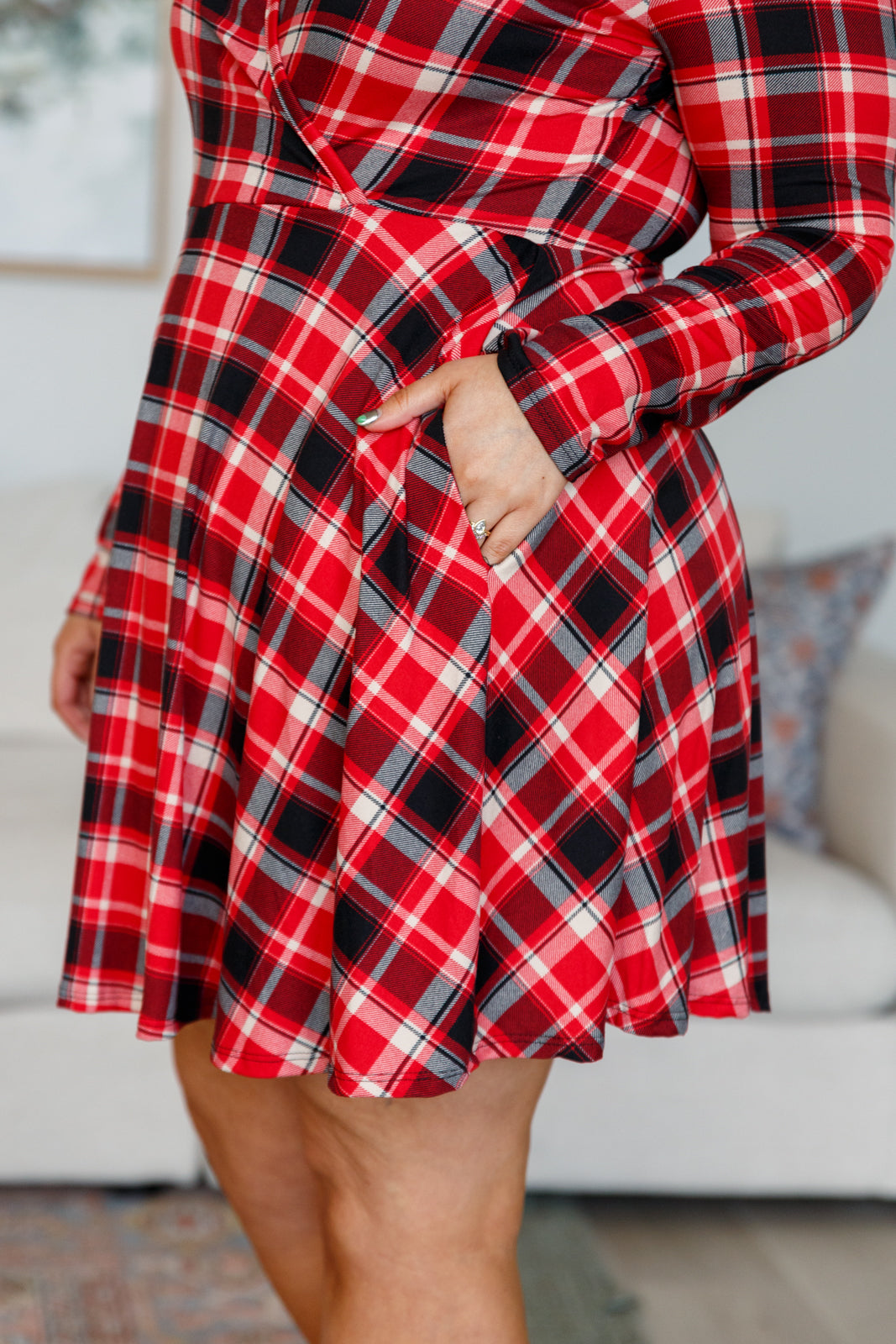 Plaid long sleeve skort dress with faux surplice wrap front, V-neckline, hidden side pockets, built-in shorts, and 8-snap crotch closure.