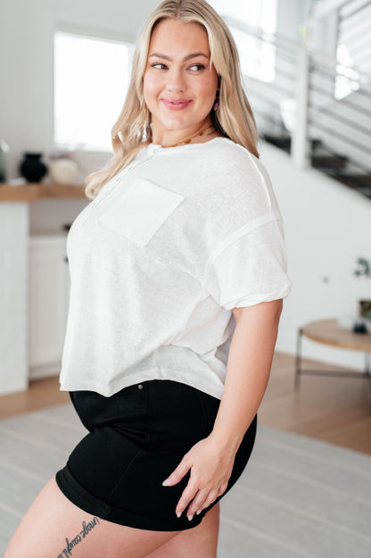 Plus size side view of Khloe Henley Top in ivory, highlighting scooped high-low hem and relaxed drop shoulder fit.