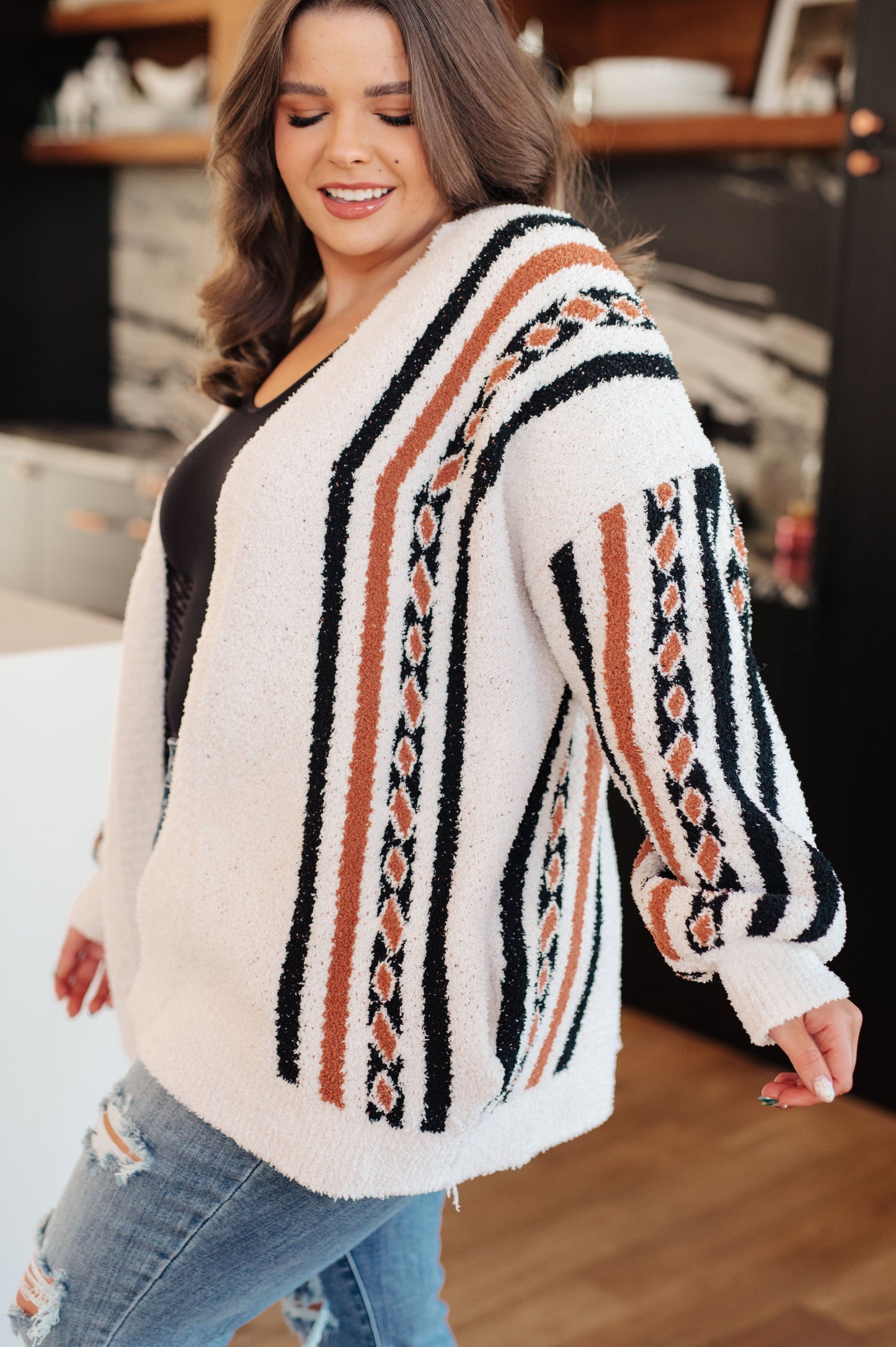 Side angle of plus size Hollis Aztec Print Cardigan highlighting soft mid-weight fabric.