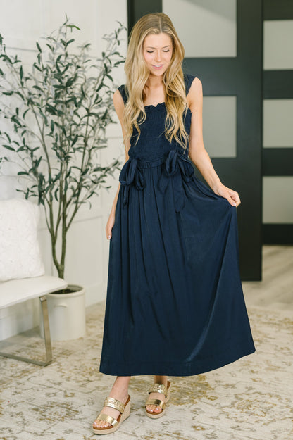 Front view of Holland Midi Dress in Navy showing smocked elastic bodice and midi length.