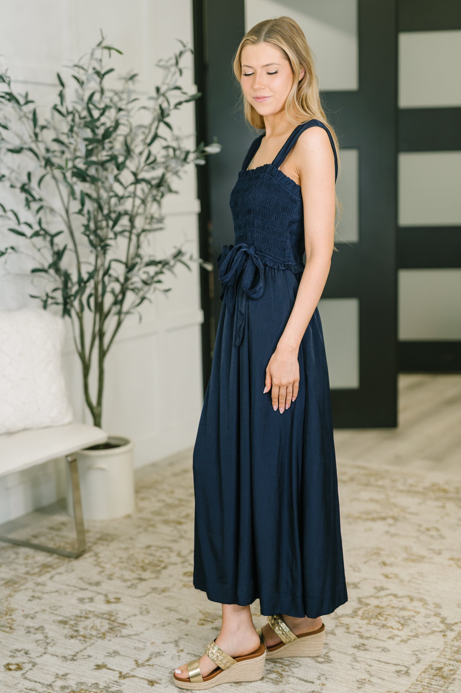 Side view of Holland Midi Dress in Navy highlighting ruffled details and poplin fabric.