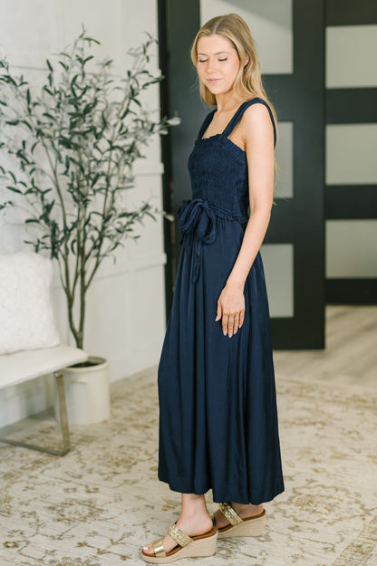 Side view of Holland Midi Dress in Navy highlighting ruffled details and poplin fabric.