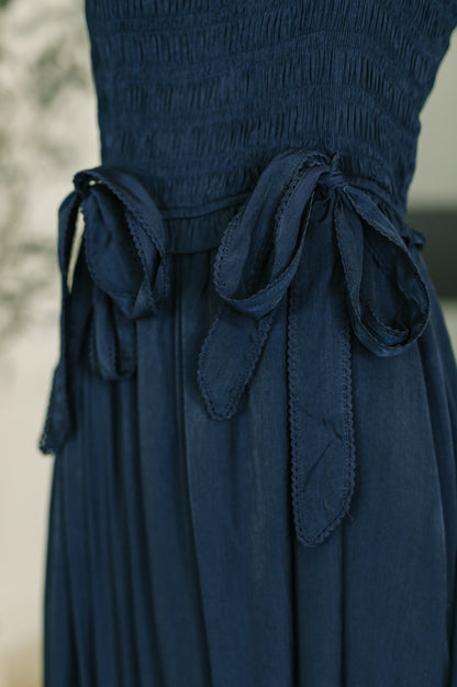 Close up of Holland Midi Dress in Navy functional bow tie neckline detail.