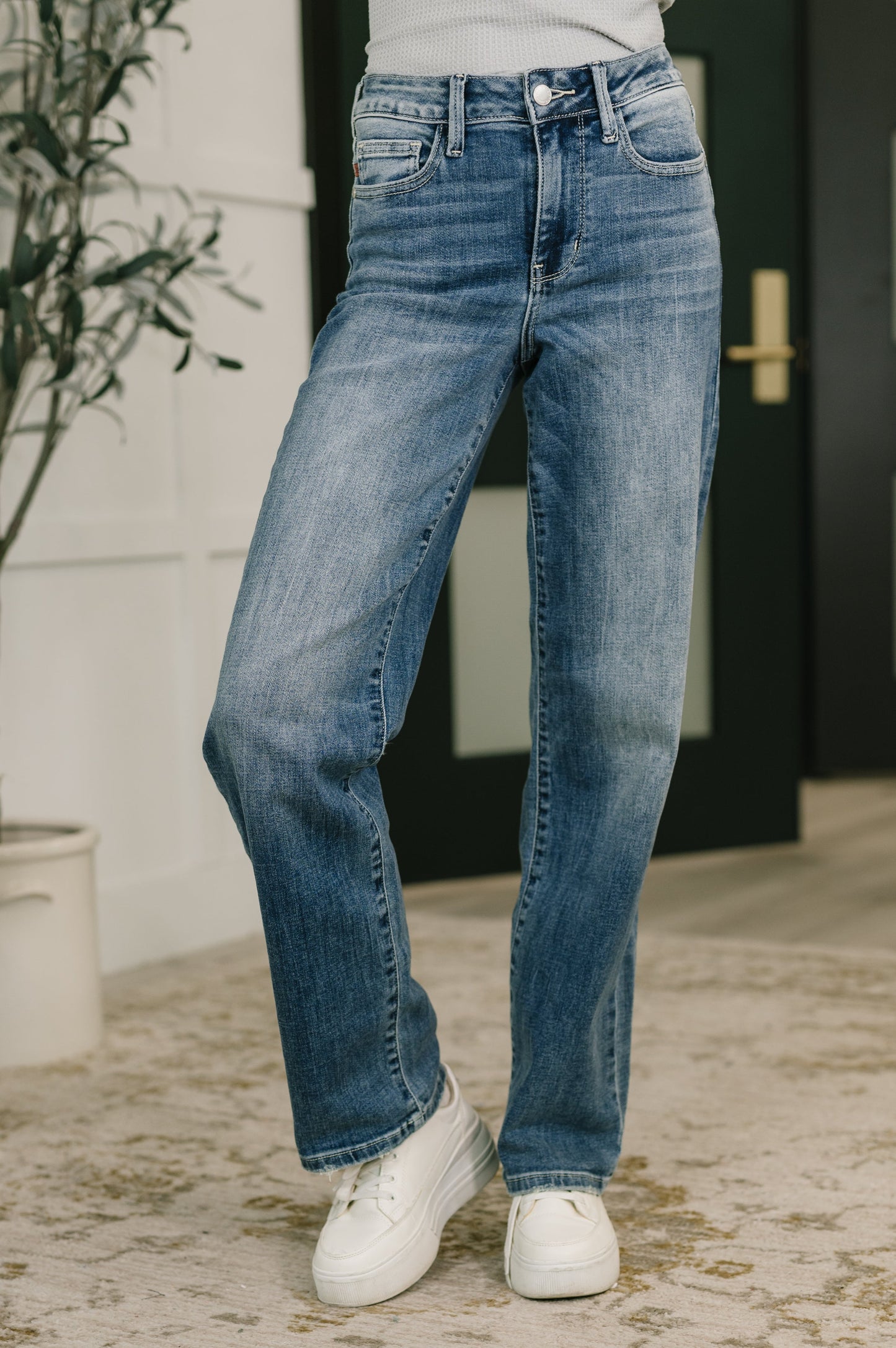 Model wearing Holly Mid Rise Straight Jeans by Judy Blue light wash straight leg denim.