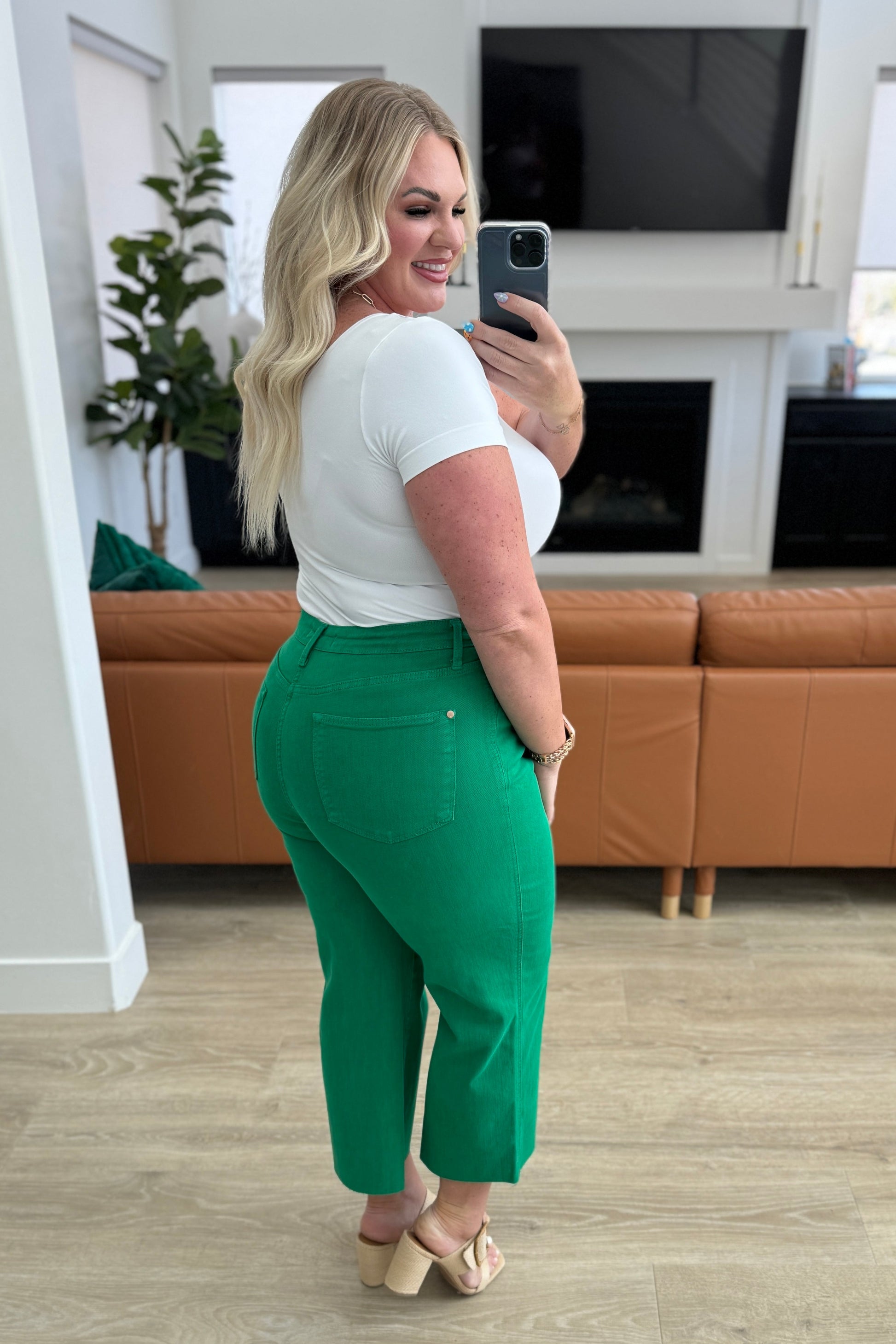 Kelly green high-rise wide leg crop jeans with raw hem and control top, featuring 4-way stretch for a comfortable, flattering fit.