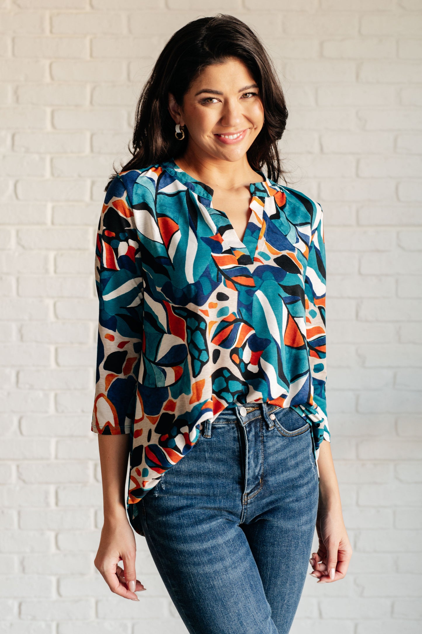 Front view of Imani Abstract Teal Top with gabby neckline and bold print.