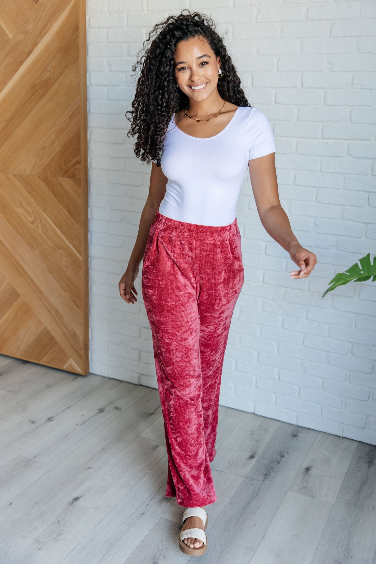 Velour set featuring a boatneck top with drop shoulders, banded hem, and short sleeves, paired with bottoms that have a cased elastic waistline, functional side pockets, and a slight flare silhouette with some stretch.