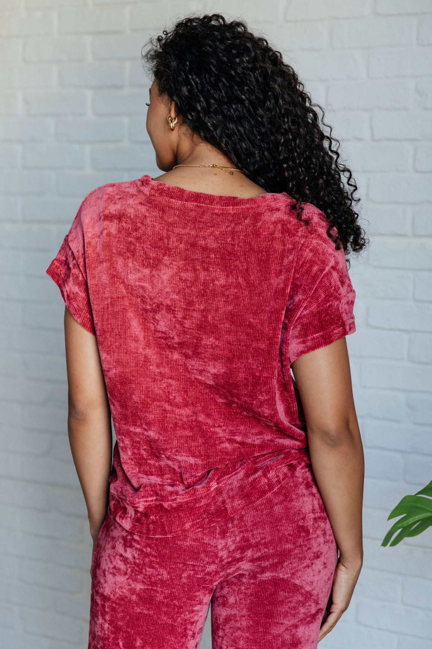 Velour set featuring a boatneck top with drop shoulders, banded hem, and short sleeves, paired with bottoms that have a cased elastic waistline, functional side pockets, and a slight flare silhouette with some stretch.