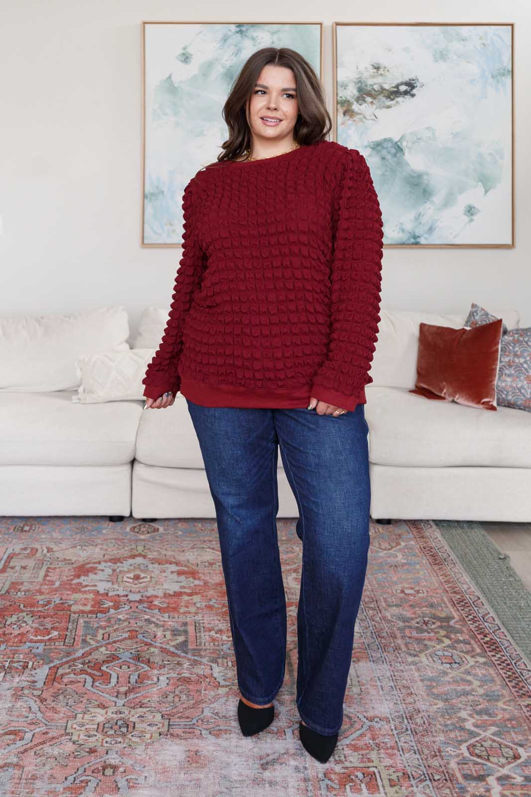 Wine-colored pullover with a crew neckline, long puff sleeves, slight shoulder padding, and ribbed cuffs and hem. Made from bubble-textured knit fabric.