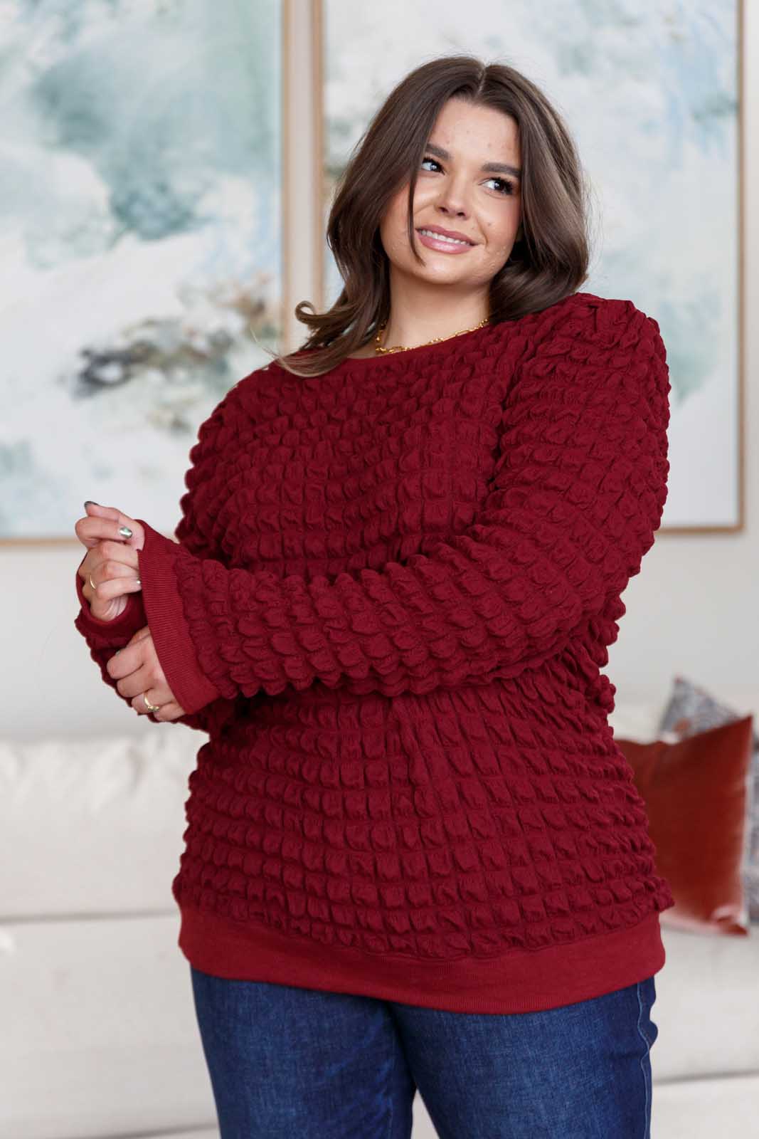 Wine-colored pullover with a crew neckline, long puff sleeves, slight shoulder padding, and ribbed cuffs and hem. Made from bubble-textured knit fabric.