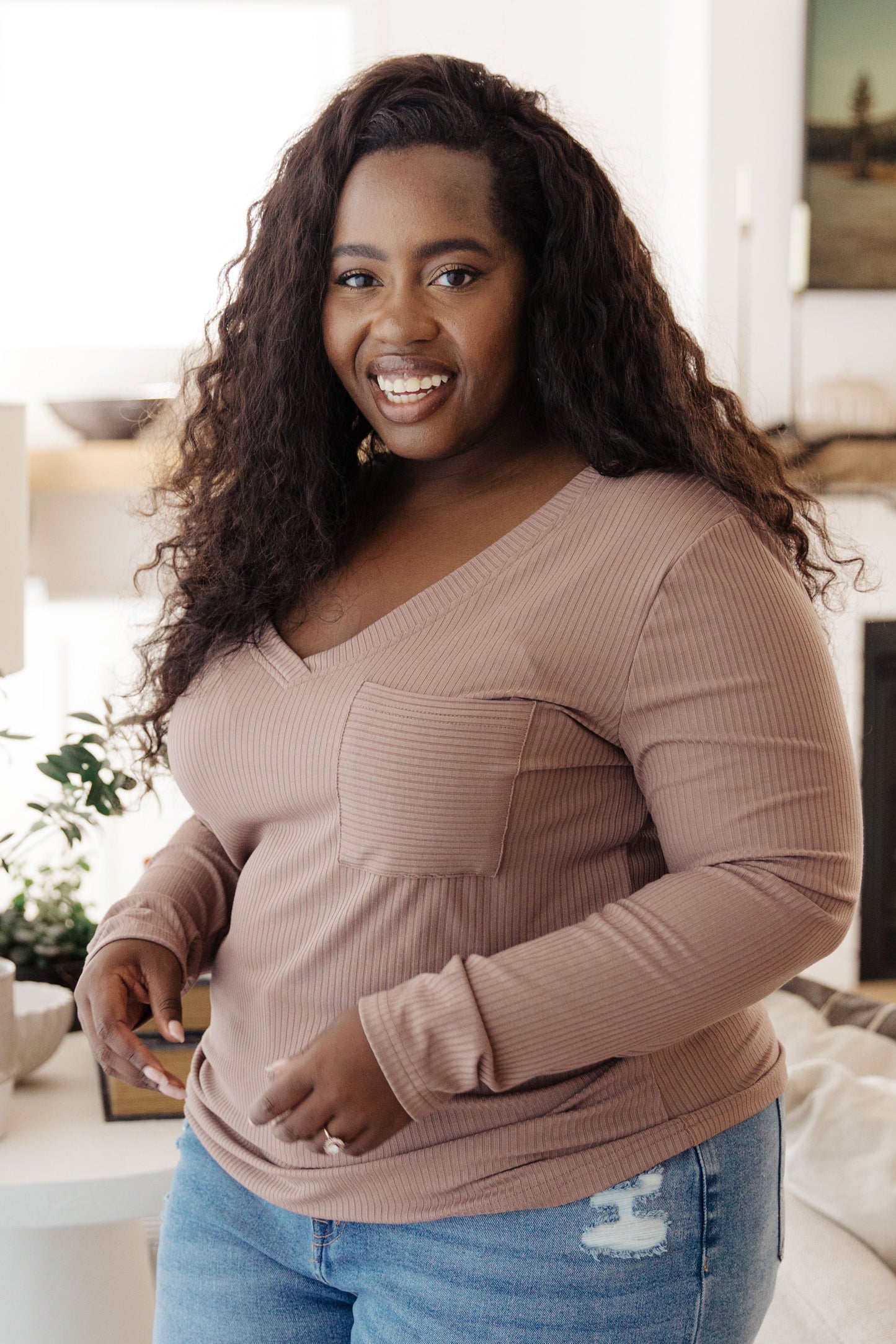 Side angle of plus size Indie Long Sleeve V-Neck Top in Beige highlighting soft stretch knit.