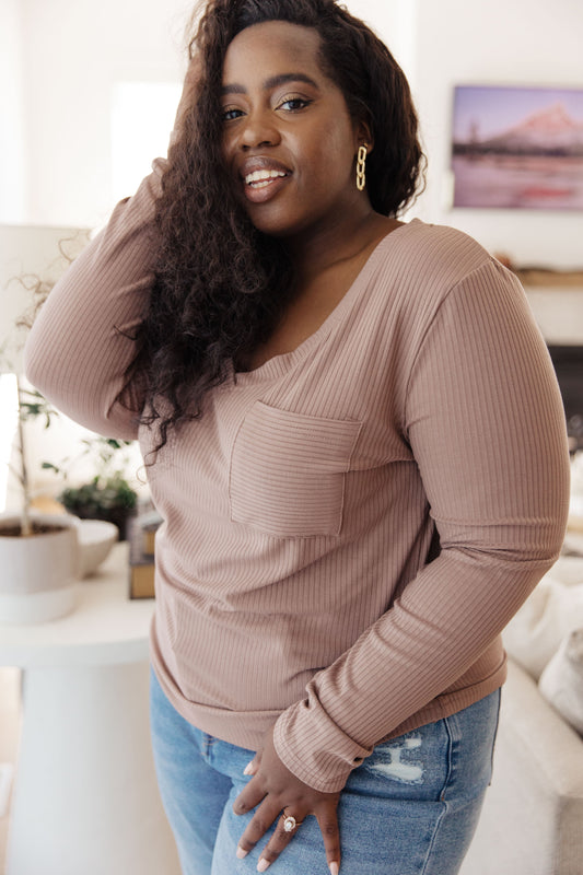 Plus size model wearing Indie Long Sleeve V-Neck Top in Beige with ribbed knit fabric.