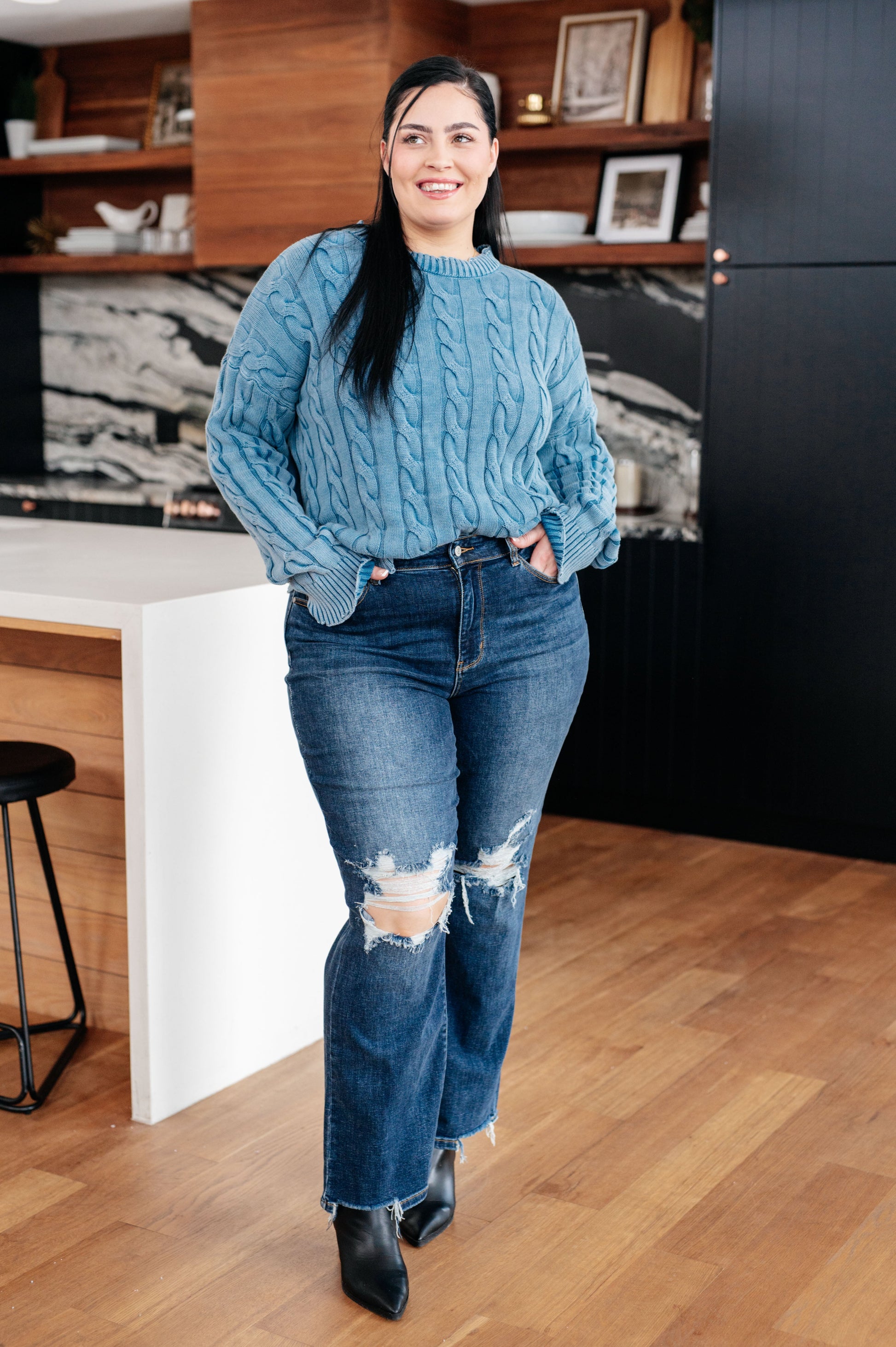 Plus size model wearing the Drea Cable Knit Sweater in mineral washed blue with drop shoulder.