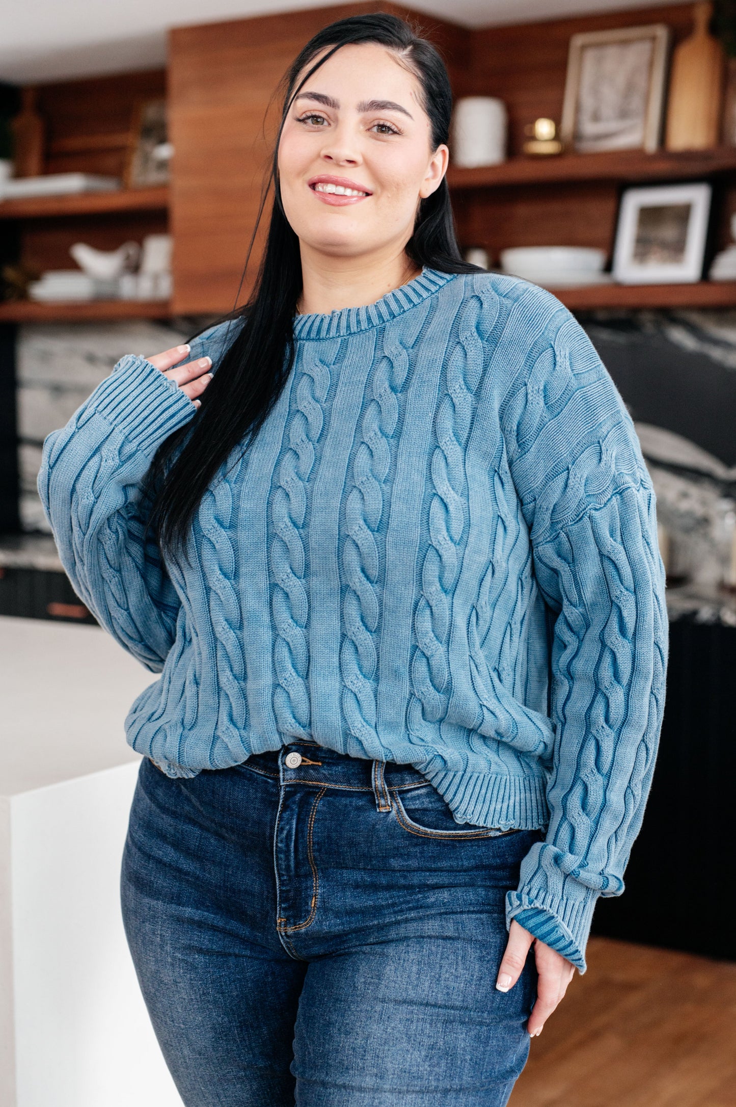 Angled view of the plus size Drea Cable Knit Sweater showing cable knit and mineral wash effect.