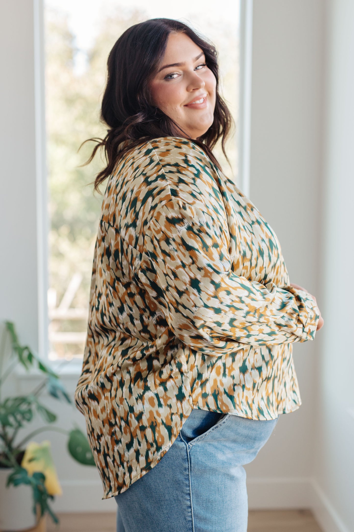 Mustard and tan abstract print blouse made from poly satin, featuring a collared neckline, button front fastening, and buttoned sleeve cuffs.