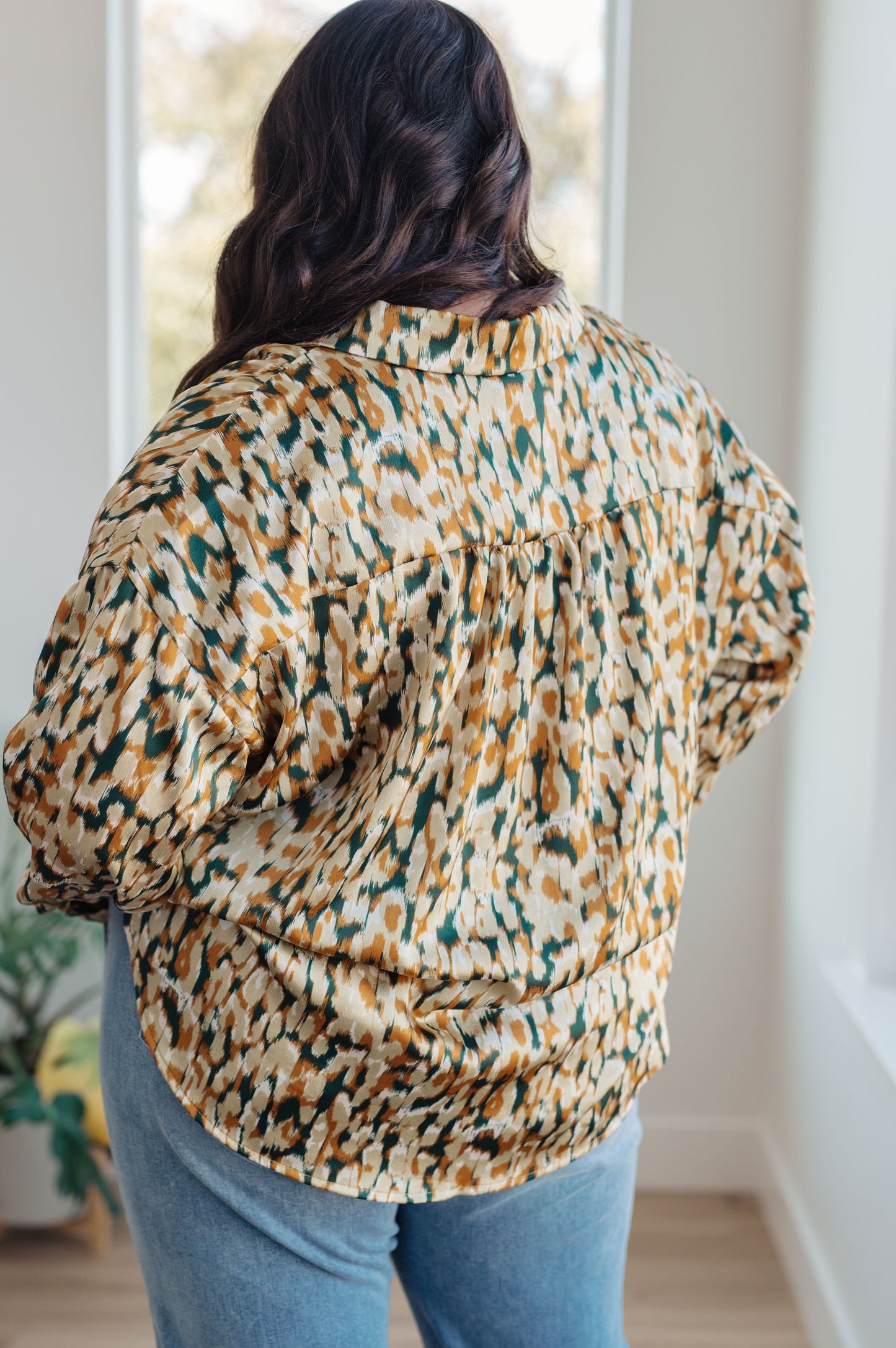 Mustard and tan abstract print blouse made from poly satin, featuring a collared neckline, button front fastening, and buttoned sleeve cuffs.