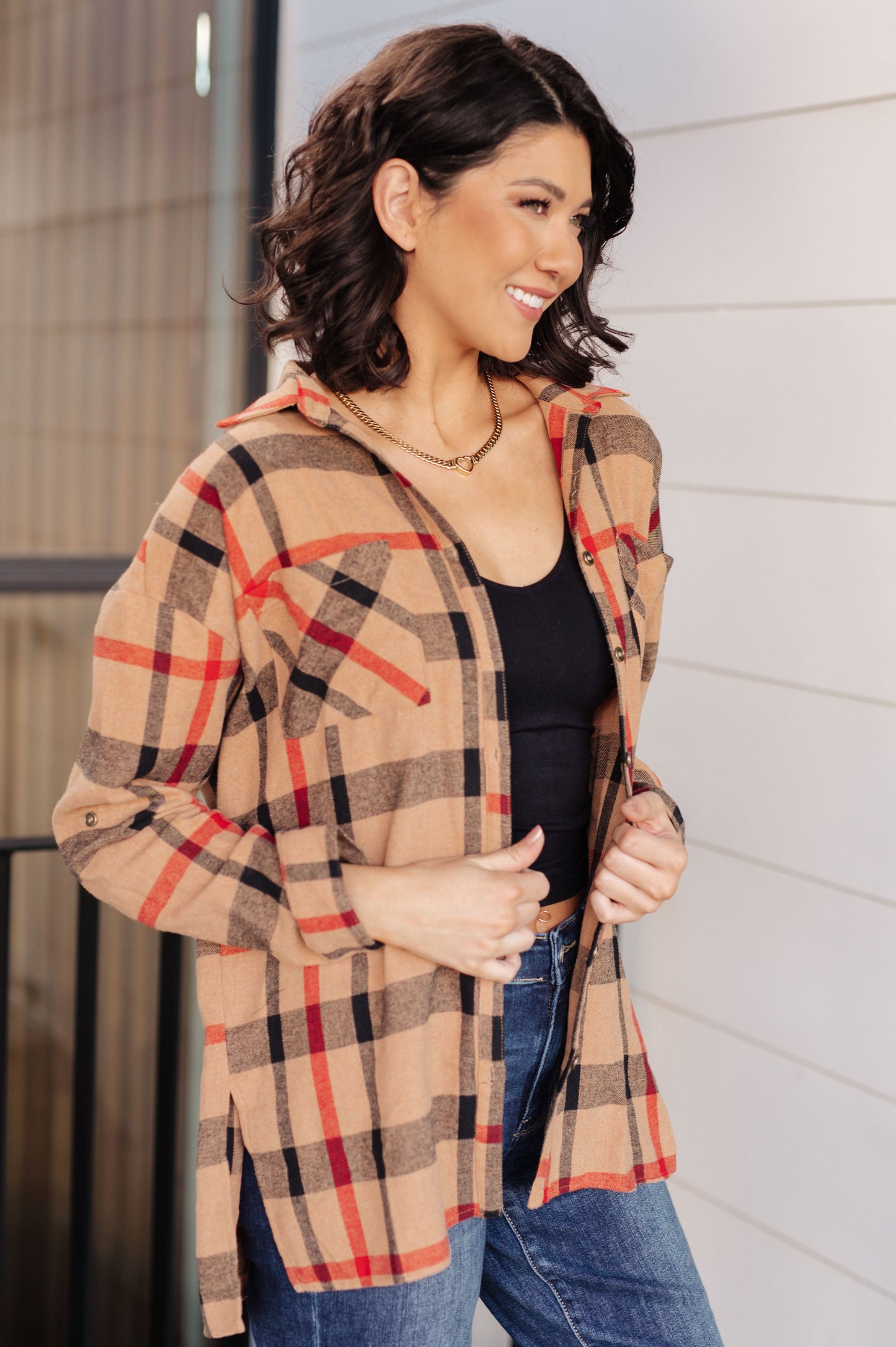 Women's lightweight flannel plaid shirt with a collared neckline, long sleeves with dropped shoulders, optional roll-tab sleeves, and side slits.