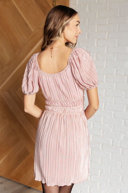 Back view of Astrid Balloon Sleeve Dress in shimmering pink with cased elastic waist.