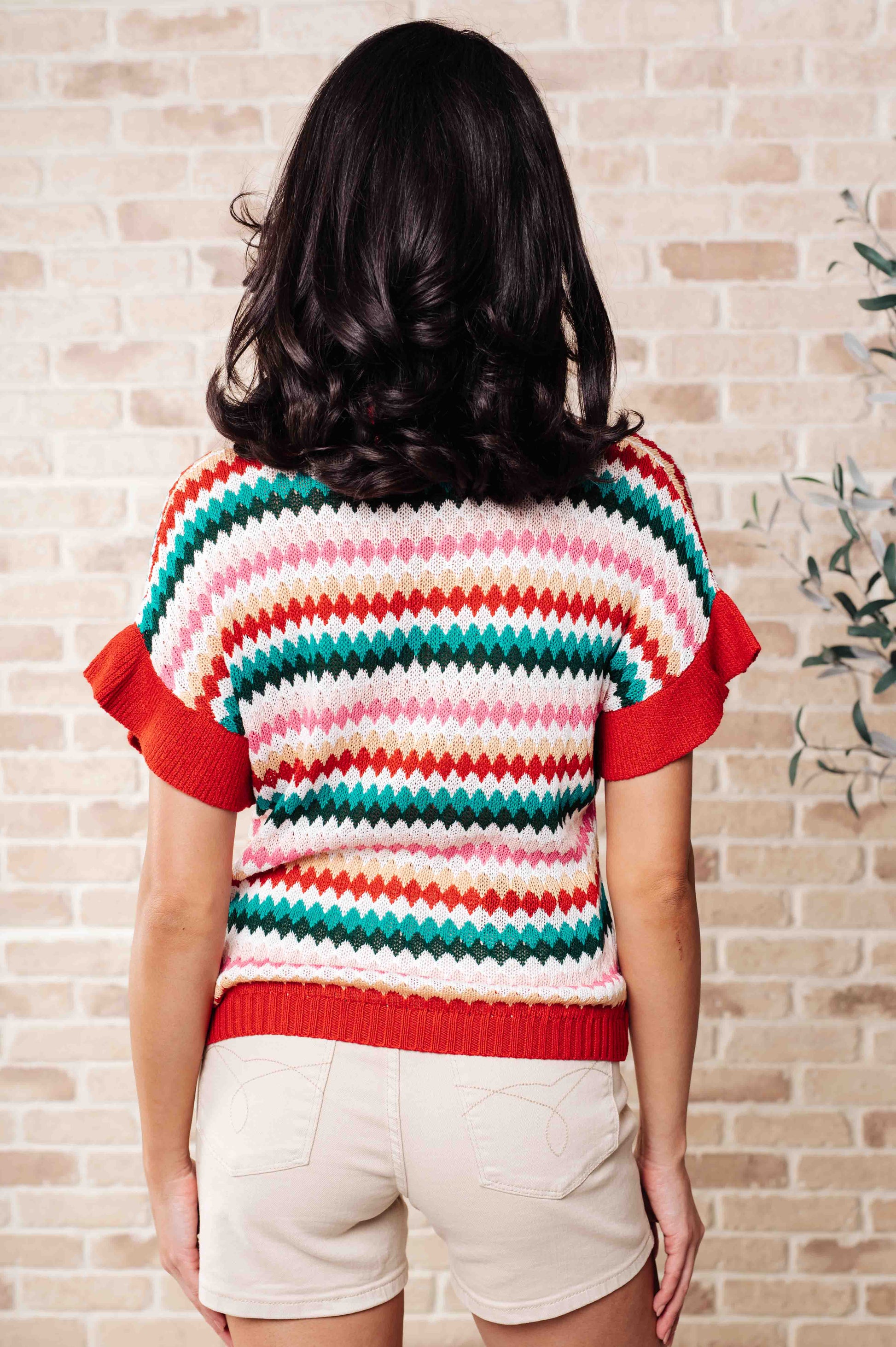 Back view of Novalee striped knit top showing colorful stripes and relaxed dolman sleeve fit