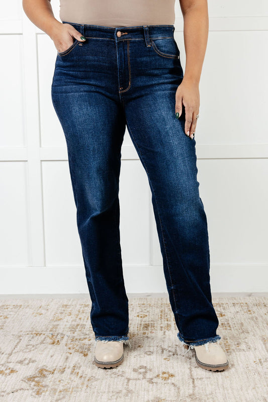  Picture of  women's plus size Mid Rise Jean with dark wash, non-distressed design, straight-leg silhouette, and frayed hem.