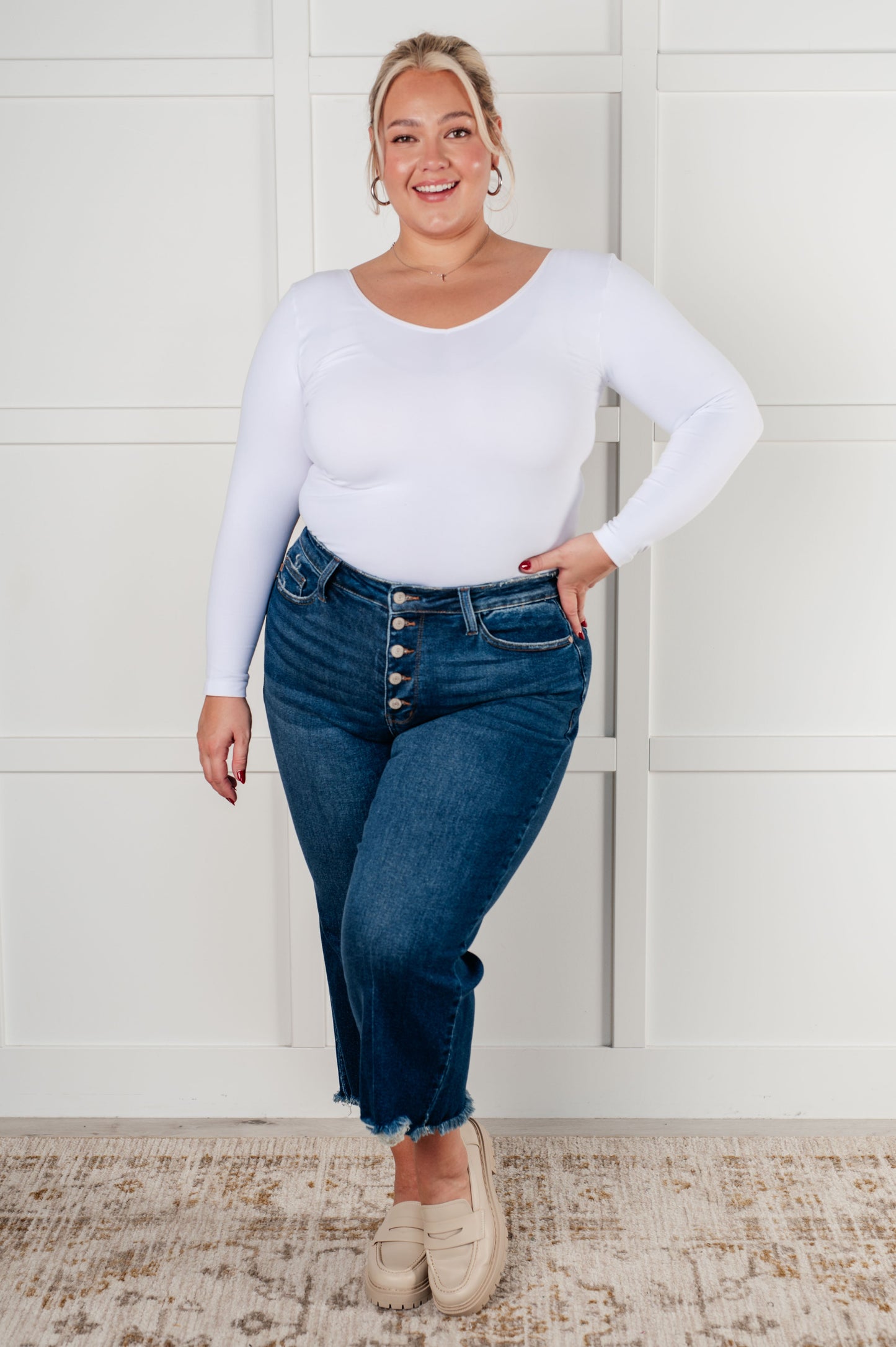 Plus size Janice High Rise Button Fly Wide Leg Crop Jeans by Judy Blue in a dark wash. Features a high-rise waist, button fly closure, wide leg crop silhouette, raw hem, and 4-way stretch for comfort and style. Perfect for a playful yet sophisticated look.