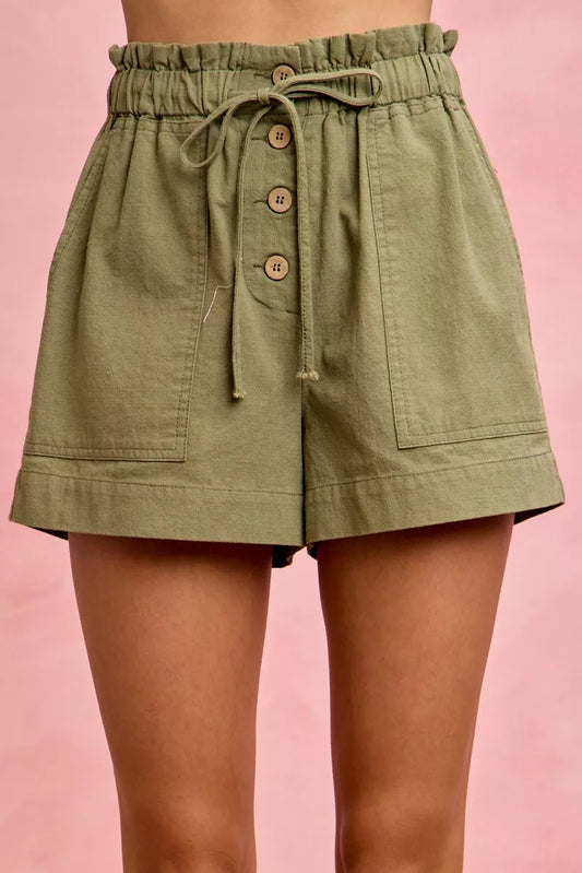 Jessa paper bag twill shorts in olive with patch pockets and drawstring waist.