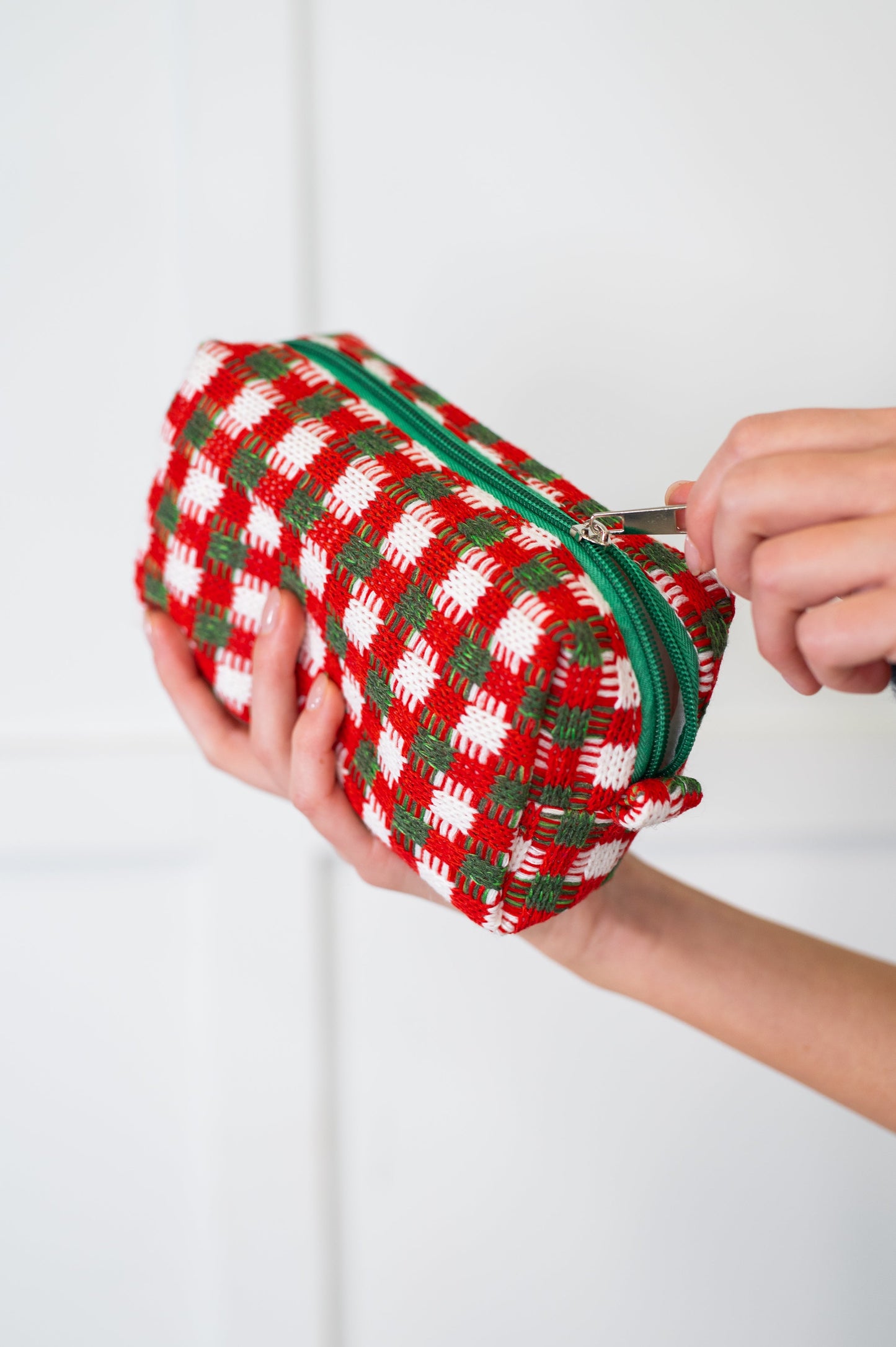 Detail shot of Jolly Holiday Textured Woven Zip Bag’s crochet-style stitching.