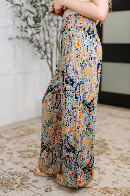 Side view of beige floral wide leg pants showing flowy wide leg silhouette.