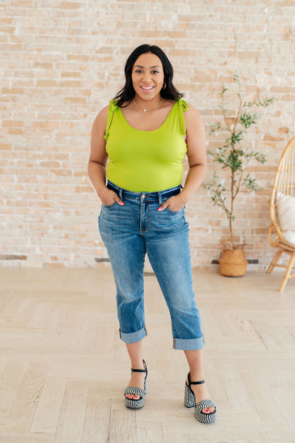 Plus size full body view of Juska Bodysuit in lime green, showcasing scoop neckline, adjustable straps, and body-hugging fit.