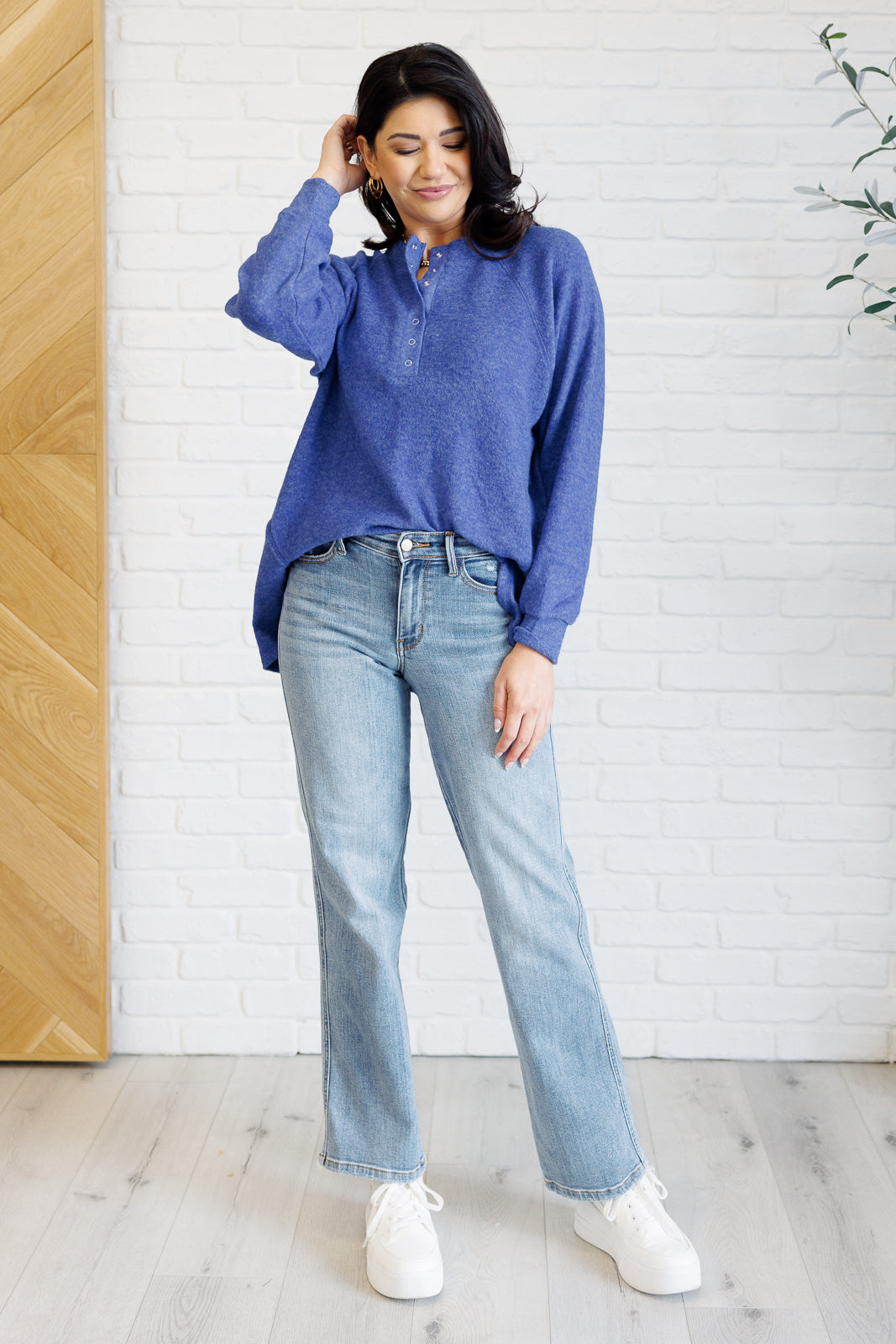 Bright blue long-sleeve tee made from soft melange hacci knit fabric. Features a round neckline with half-snap buttons, raglan sleeves, and banded cuffs.