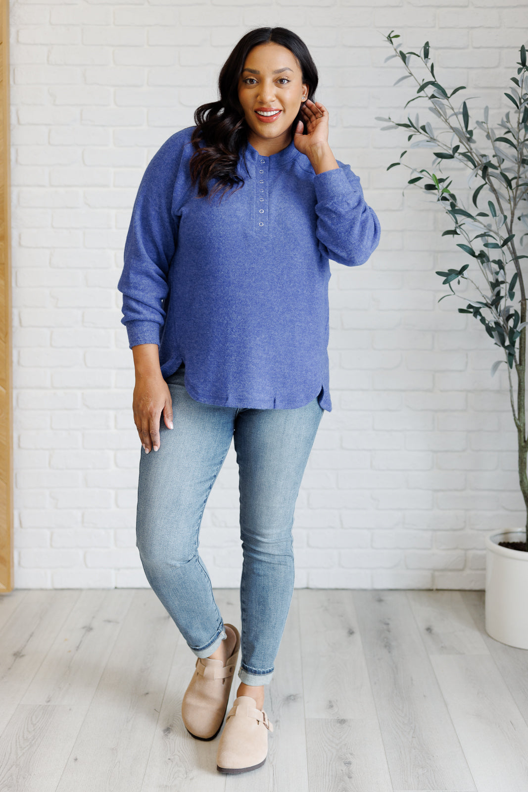 Bright blue long-sleeve tee made from soft melange hacci knit fabric. Features a round neckline with half-snap buttons, raglan sleeves, and banded cuffs.