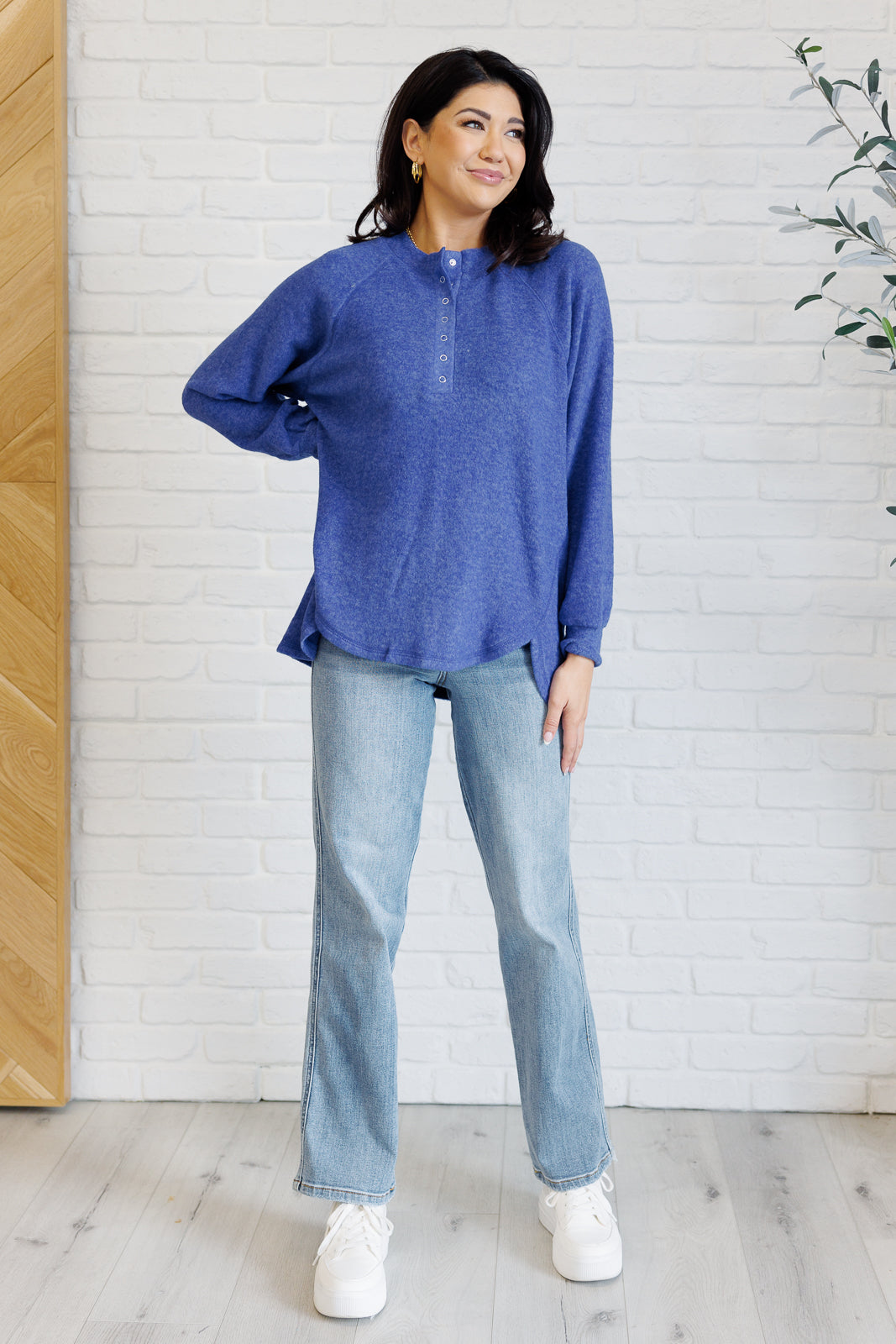 Bright blue long-sleeve tee made from soft melange hacci knit fabric. Features a round neckline with half-snap buttons, raglan sleeves, and banded cuffs.