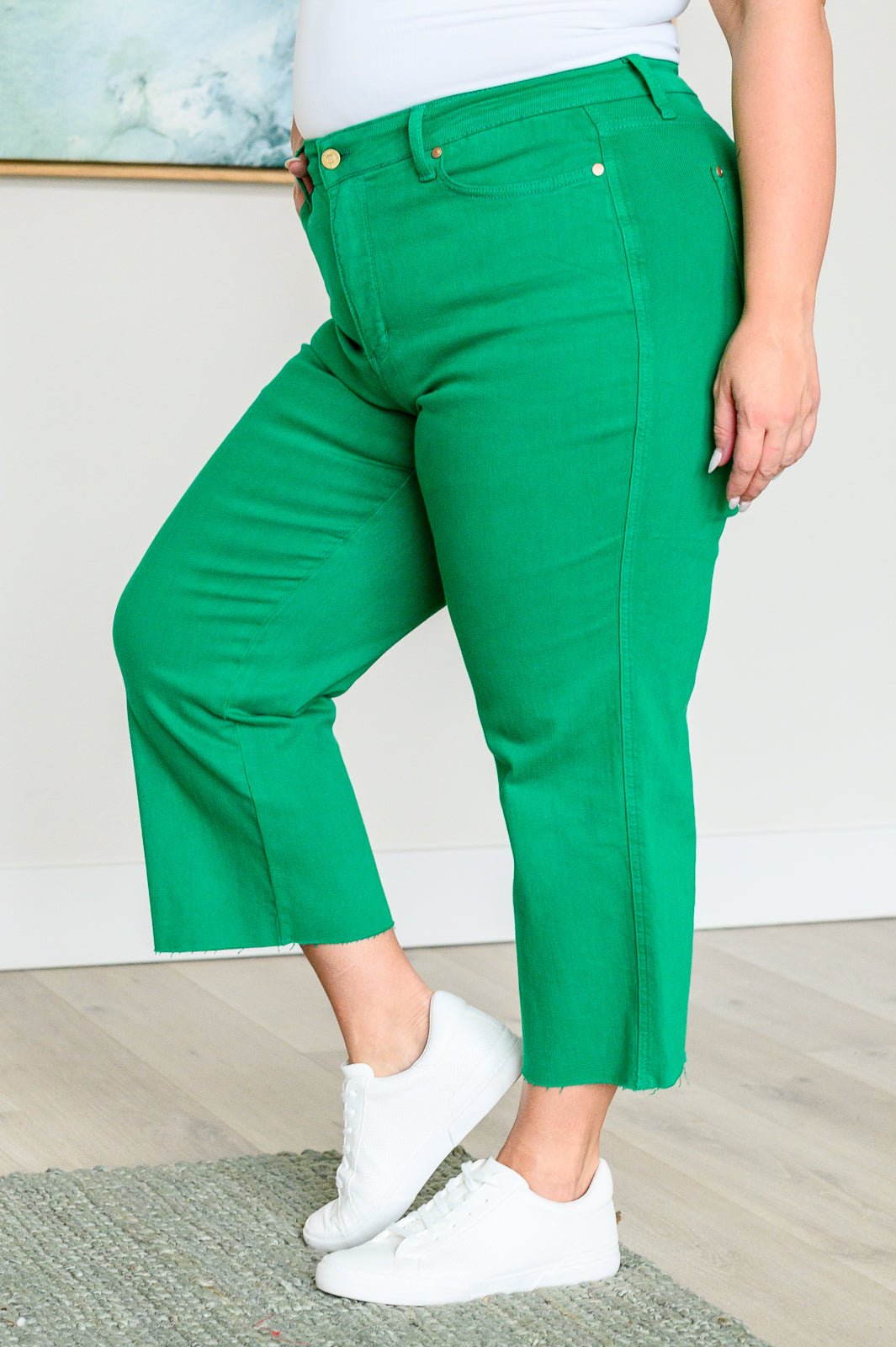 Kelly green high-rise wide leg crop jeans with raw hem and control top, featuring 4-way stretch for a comfortable, flattering fit.