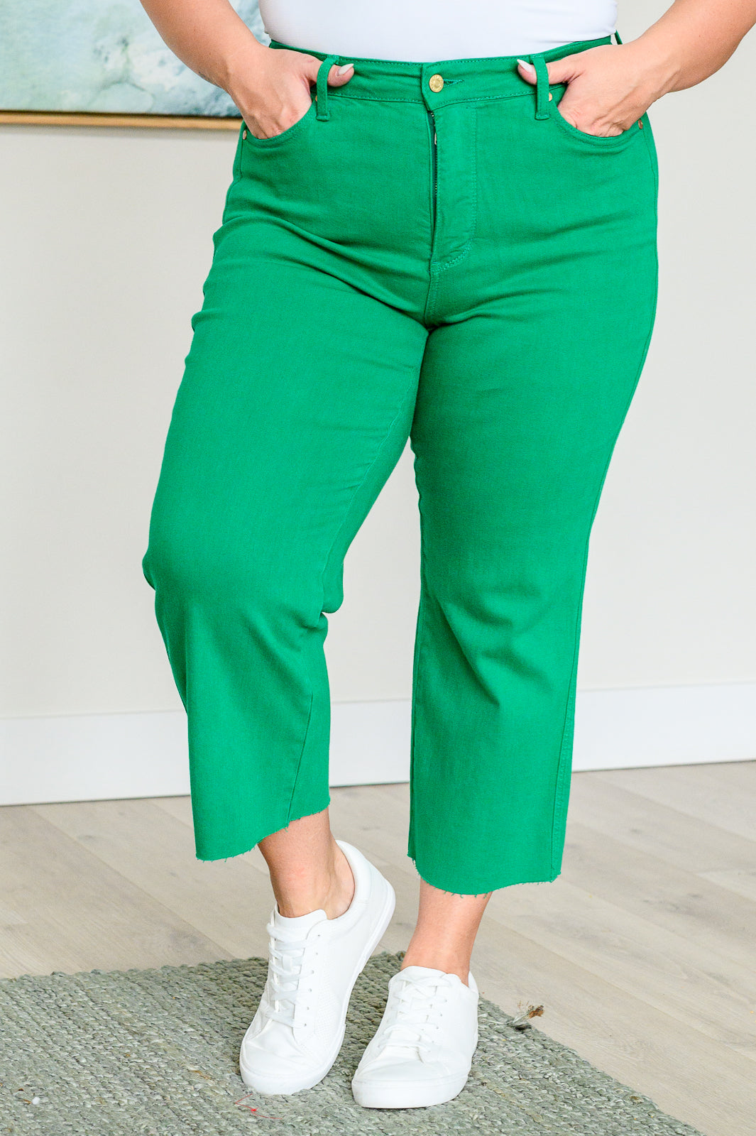 Kelly green high-rise wide leg crop jeans with raw hem and control top, featuring 4-way stretch for a comfortable, flattering fit.