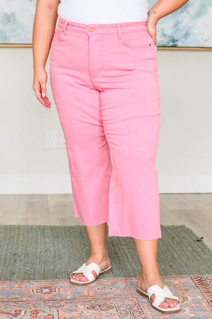 Plus size front view of Lisa High Rise Wide Leg Crop Jeans in pink showing tummy control waist and wide leg crop.