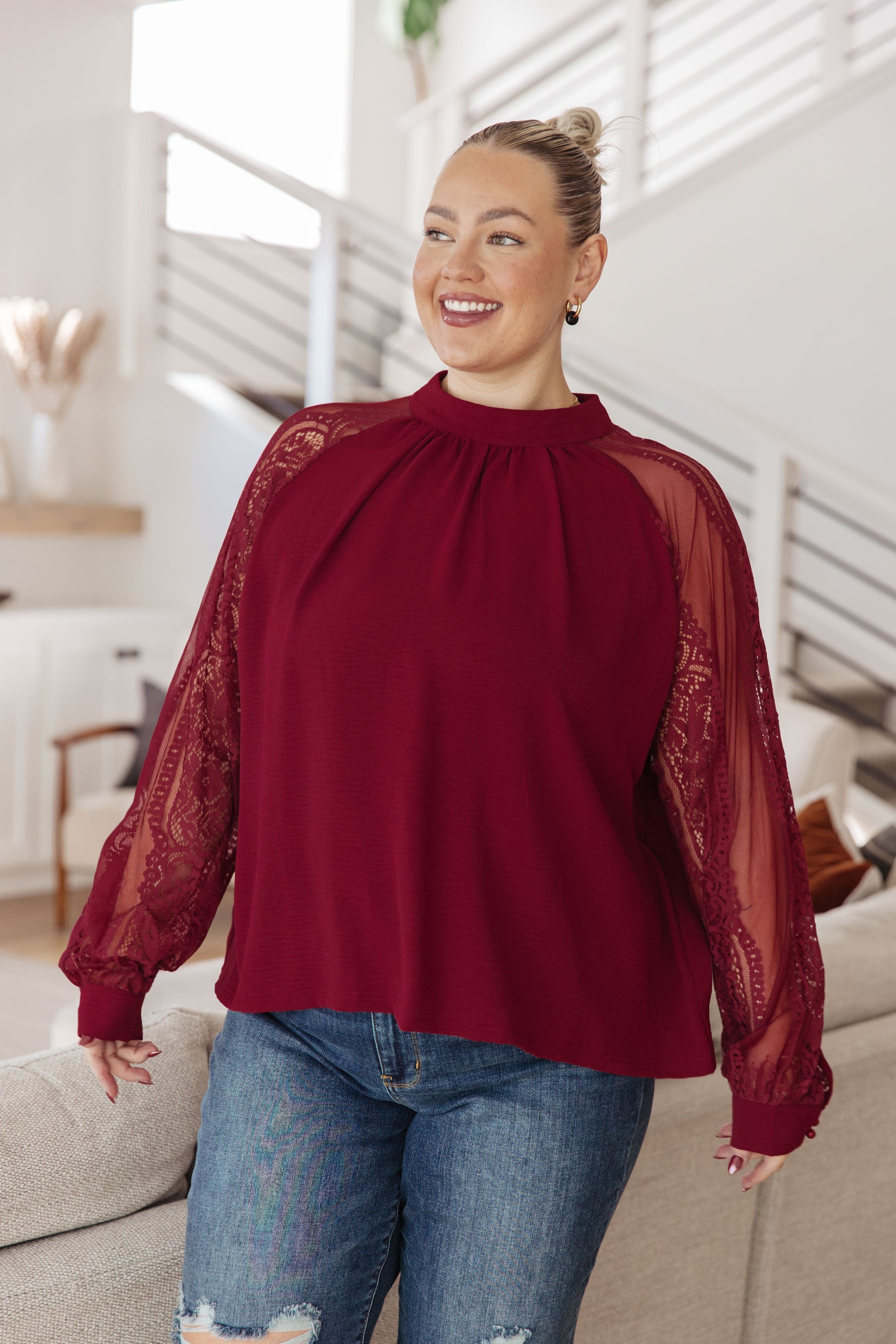 Plus size model styling Lacey Blouse with dress pants for a polished look.