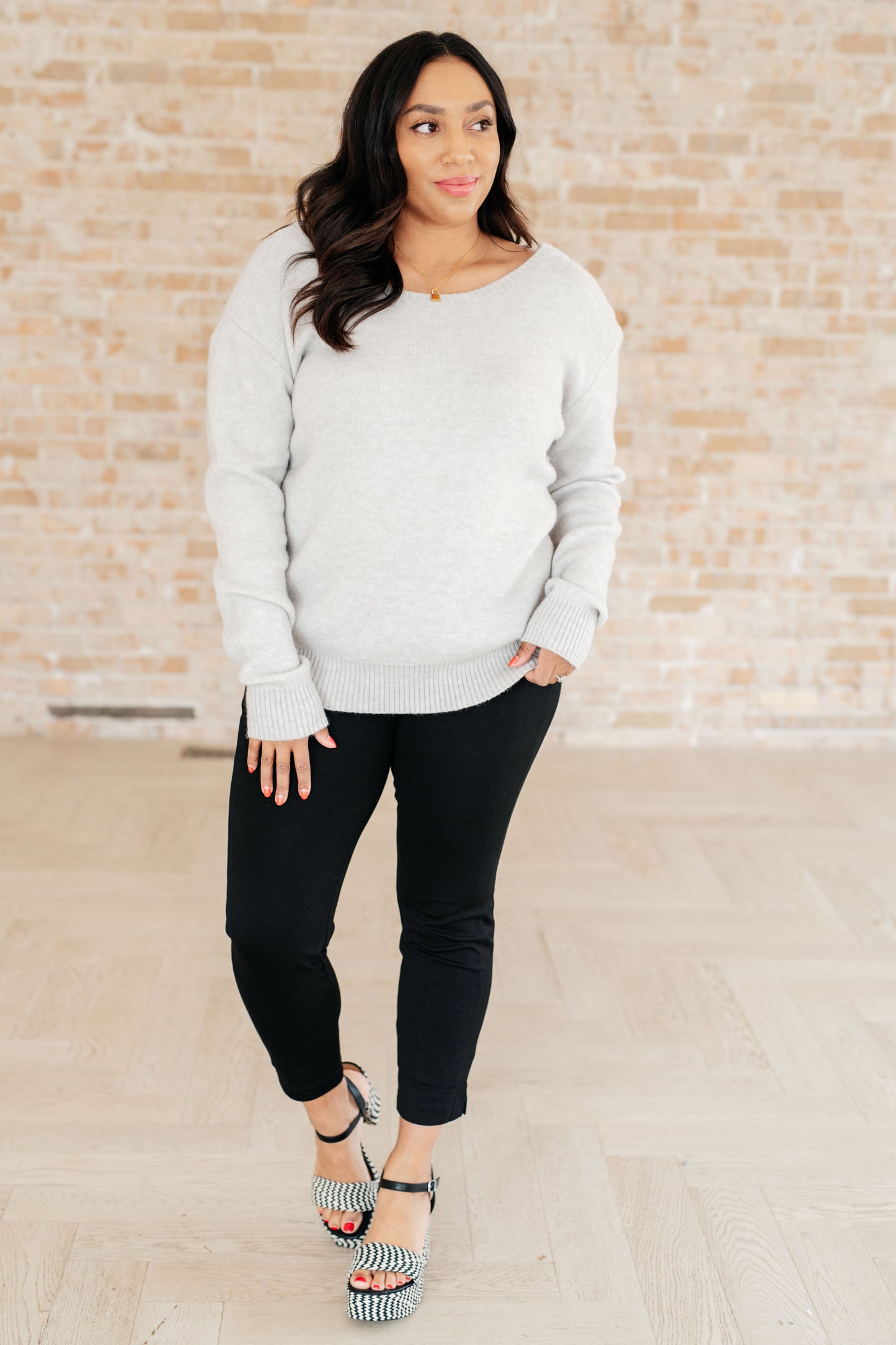 Plus size model wearing Lana Sweater Top with jeans for chic casual style.