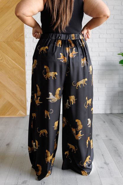 Back view of plus size Leandra Leopard Satin Wide Leg Pants elastic waist.