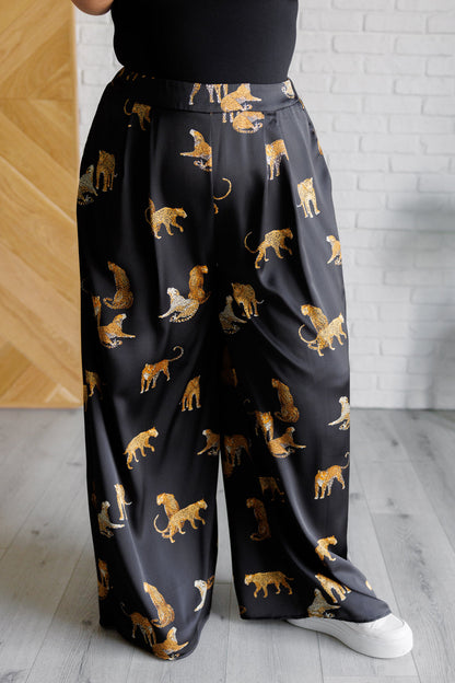 Front view of plus size Leandra Leopard Satin Wide Leg Pants pleat front detail.
