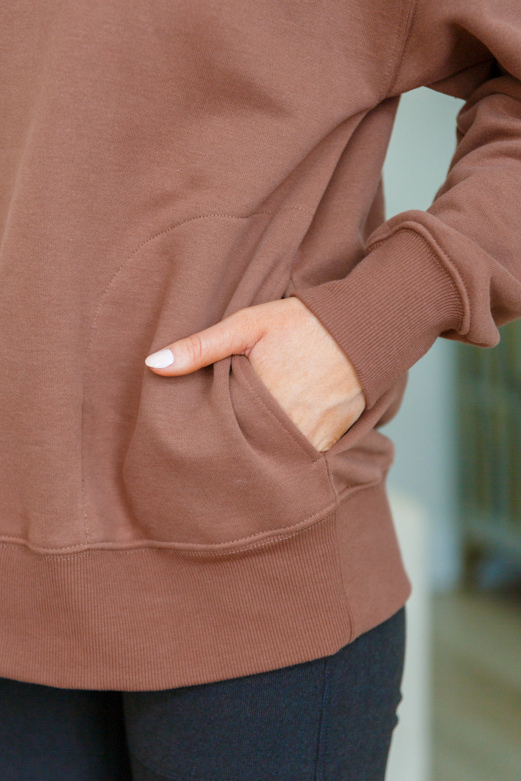 Soft cocoa sweatshirt fleece pullover with a ribbed mock neckline, long sleeves, dropped shoulders, side pockets, and a relaxed fit.