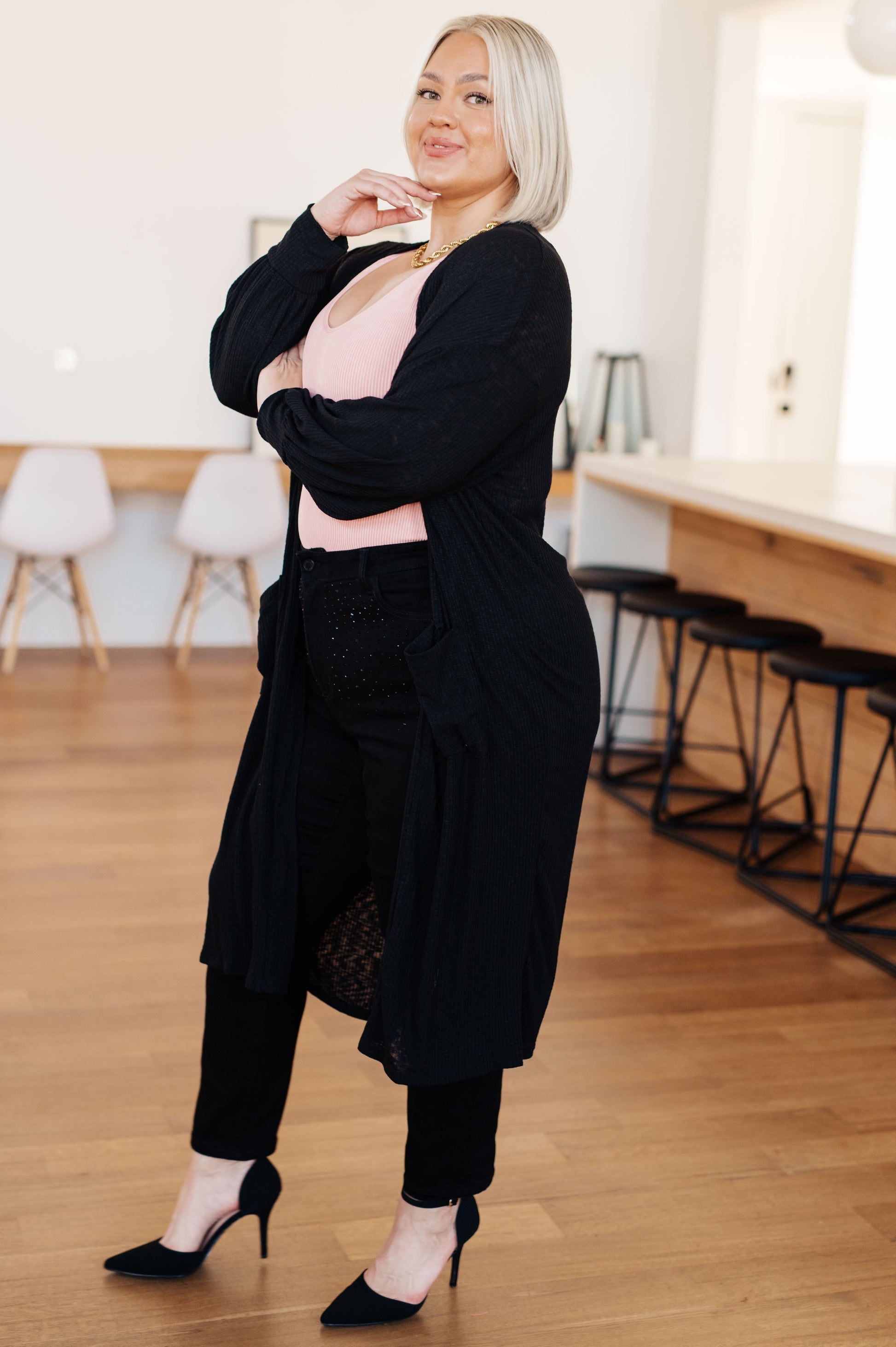 Side angle of plus size Lee Duster Cardigan in Black highlighting soft, slightly sheer fabric.