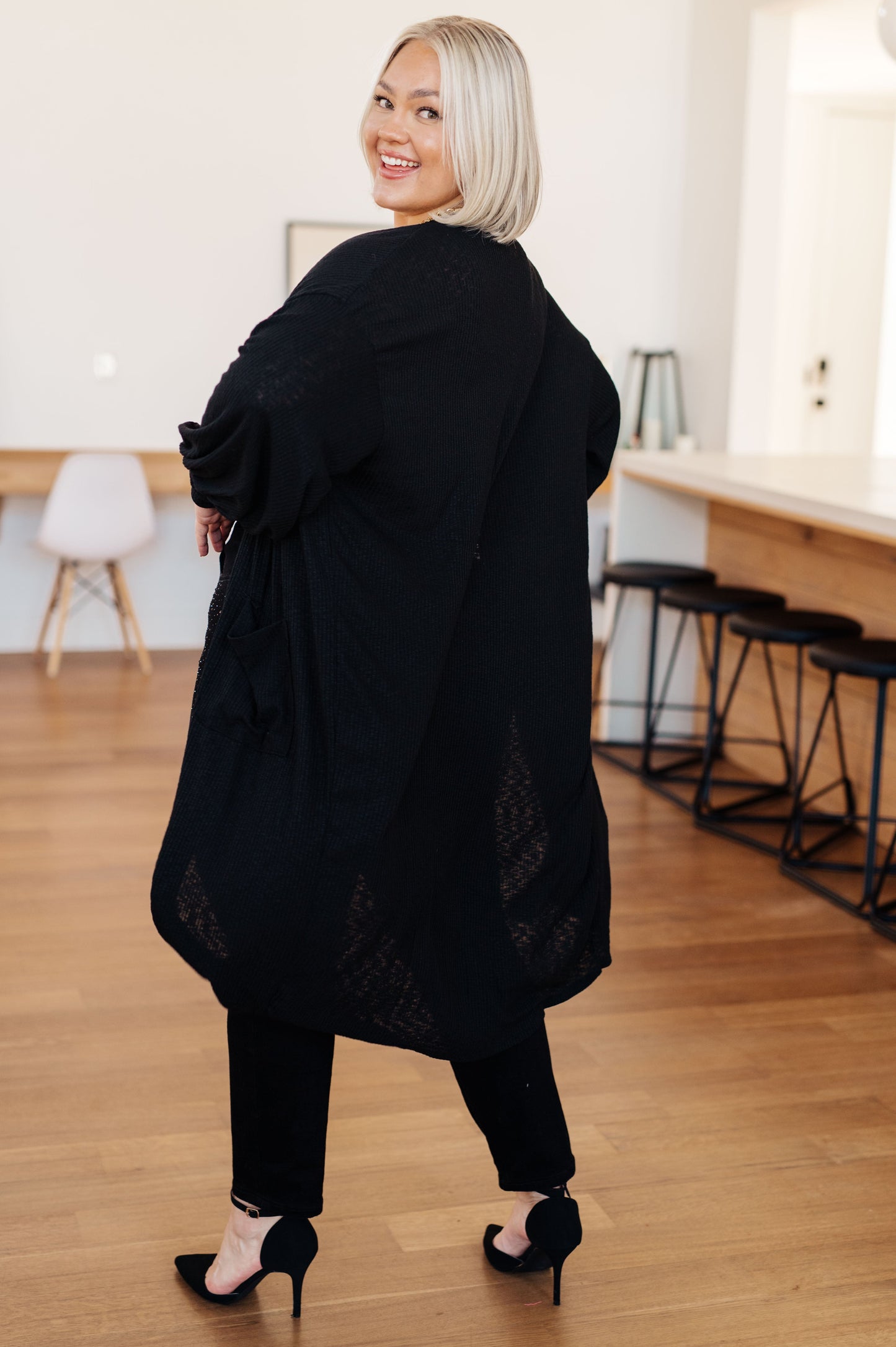 Back view of plus size Lee Duster Cardigan in Black with duster length and relaxed drape.