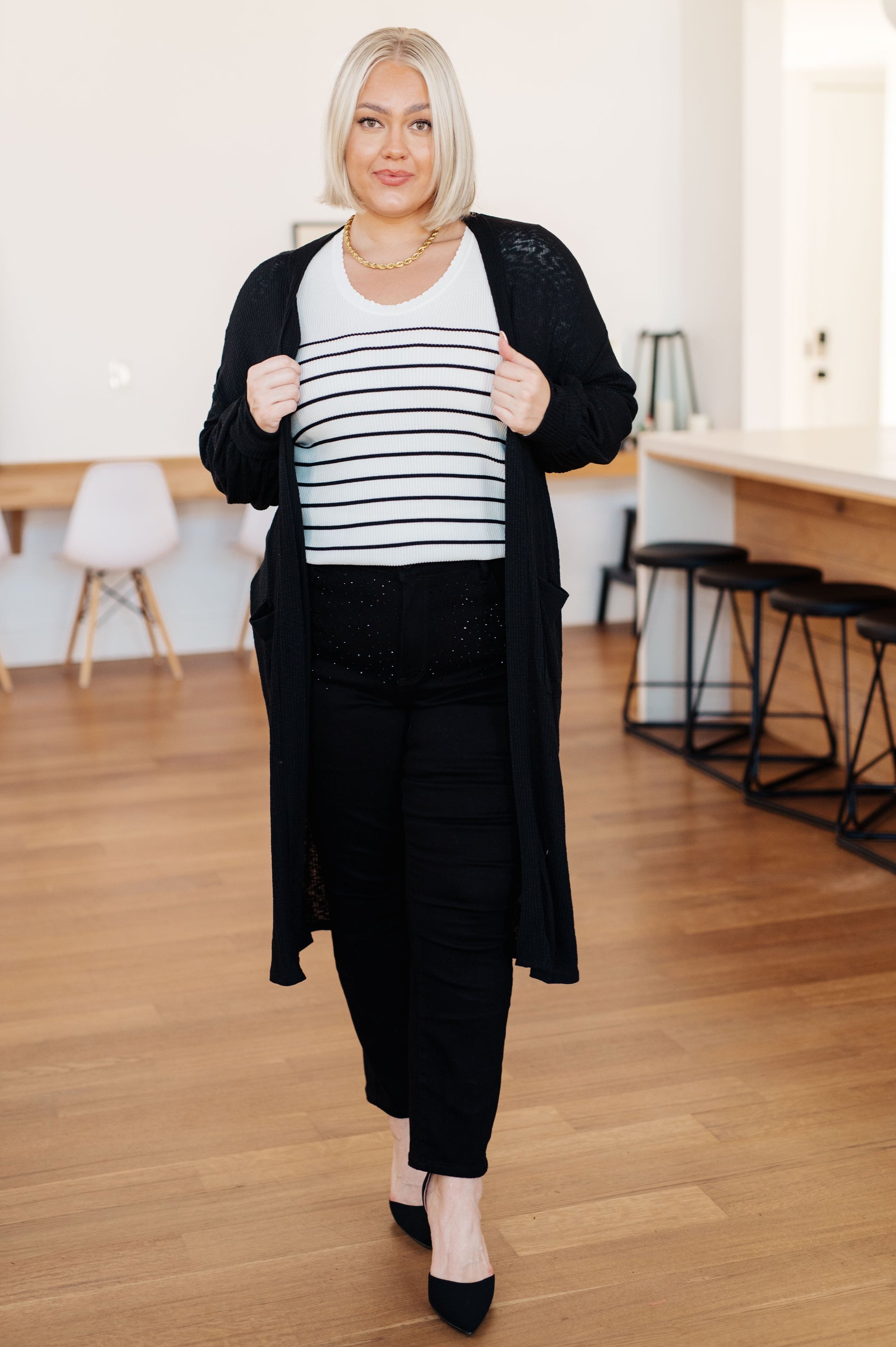Plus size model styling Lee Duster Cardigan in Black over jeans for everyday layering.