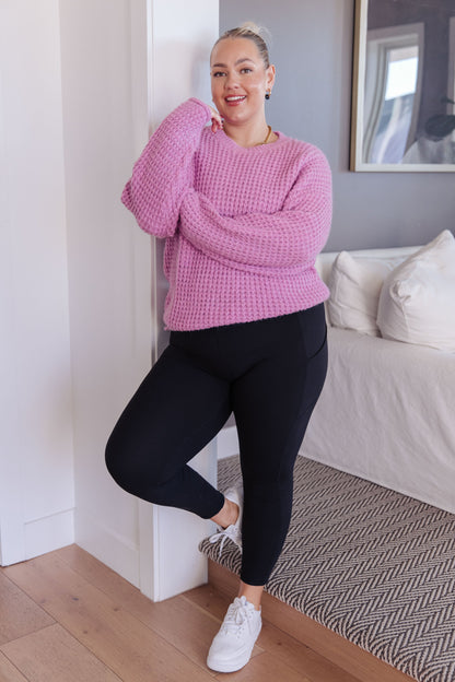 Plus size model pairing Leticia Sweater with leggings for a cozy winter outfit.