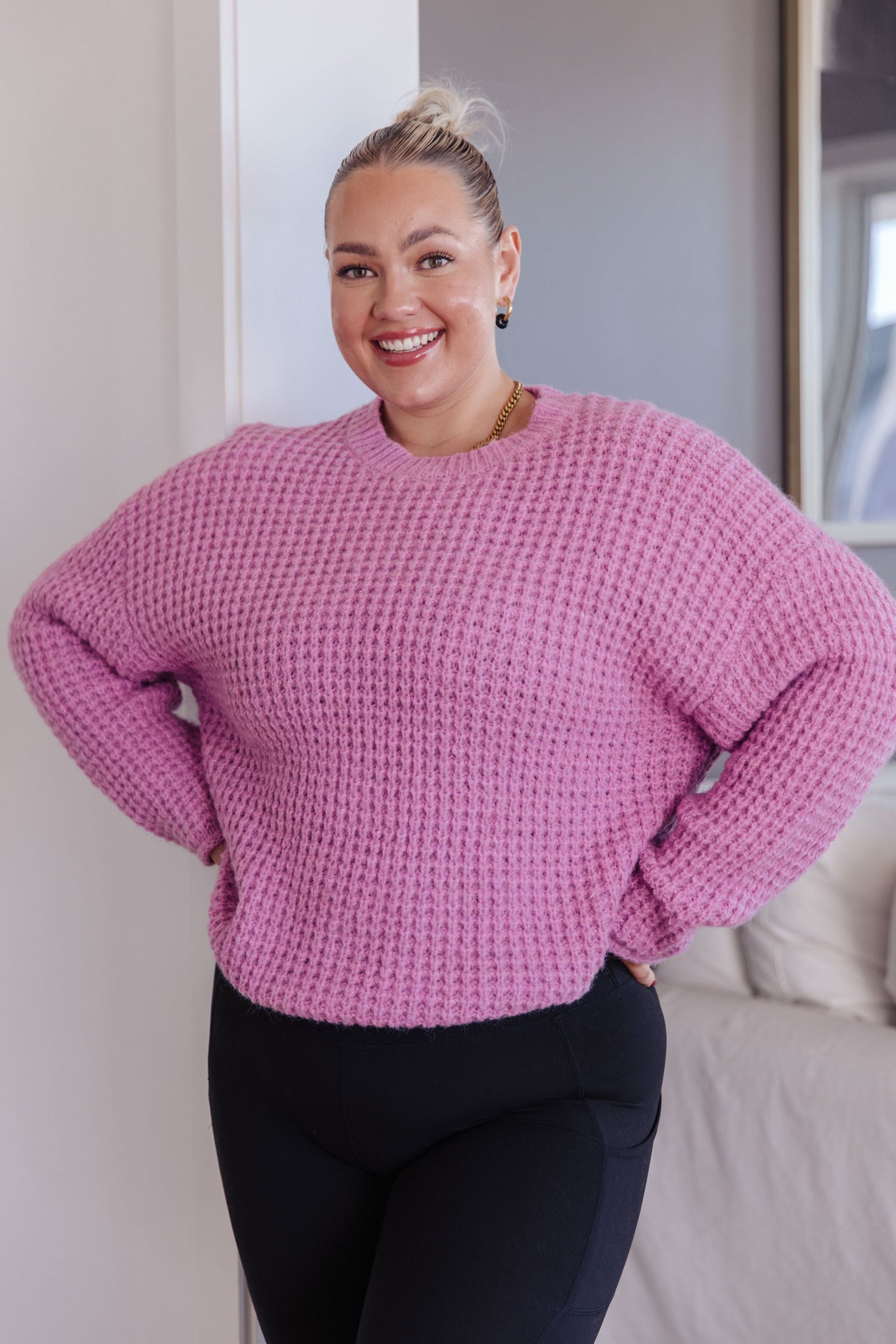 Plus size model wearing Leticia Sweater in pink with full-length waffle knit.