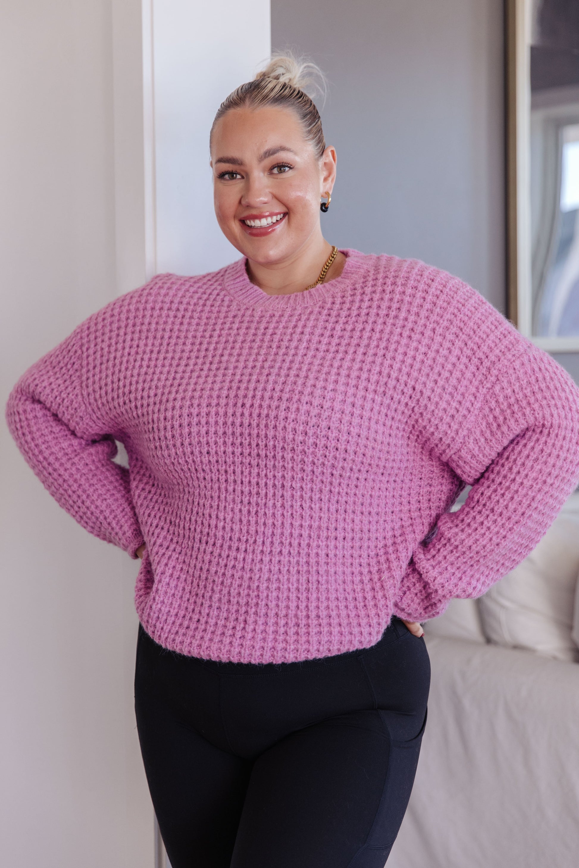 Plus size model wearing Leticia Sweater in pink with full-length waffle knit.