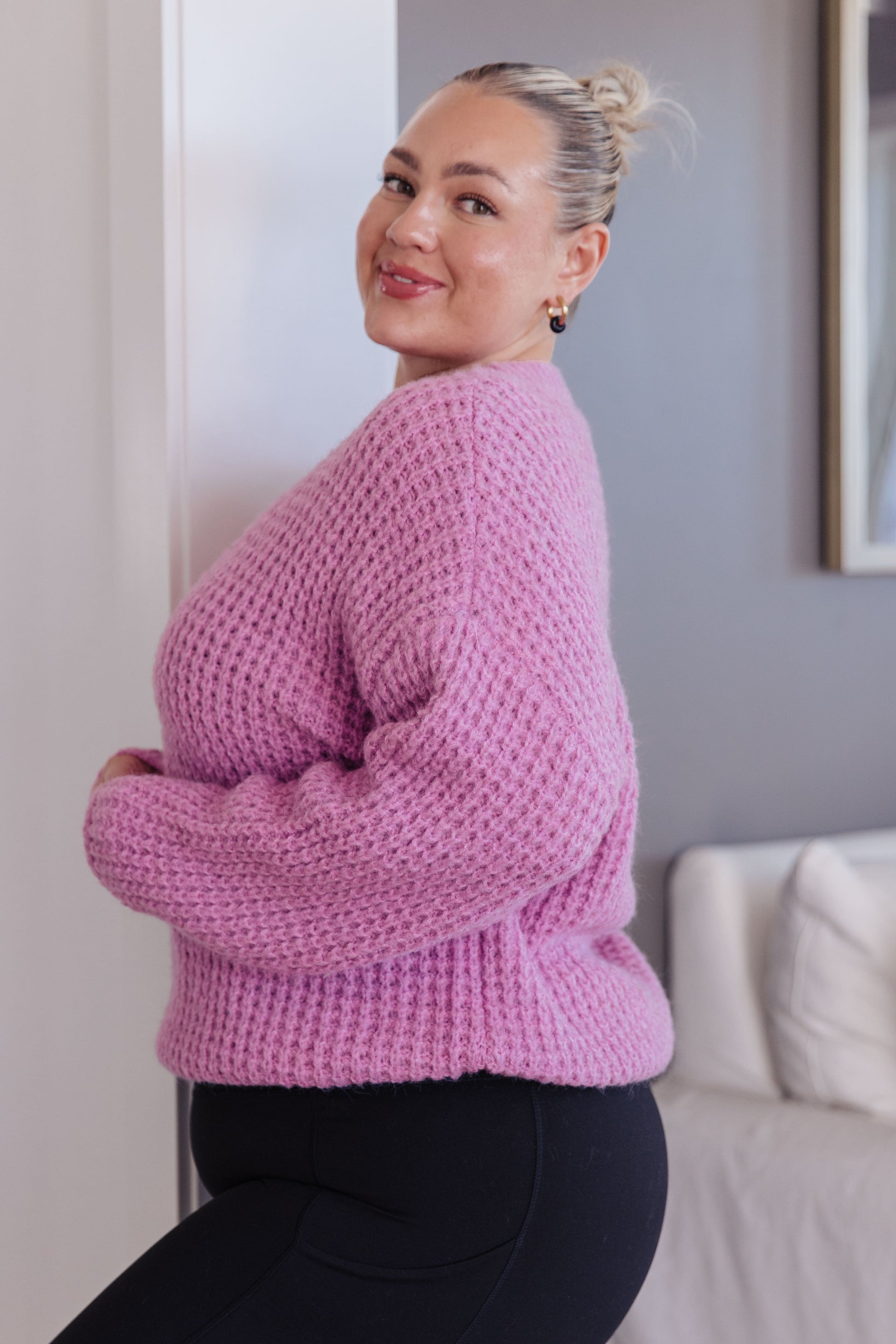 Side angle of plus size Leticia Sweater highlighting stepped hem and side slits.