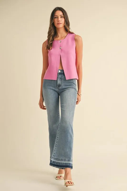 Lonnie cropped sweater vest in bubblegum pink with metal button details, sleeveless and round neckline.