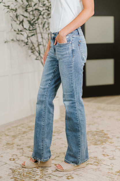 Side view of Lorena Bootcut Jeans by Judy Blue with bootcut fit, mid rise waist, and vintage wash distressed finish.