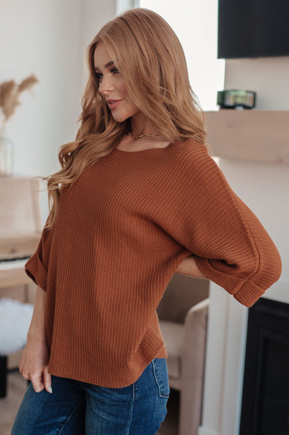 Side profile of Zizi Rust Sweater Top, relaxed fit with tacked sleeve cuffs
